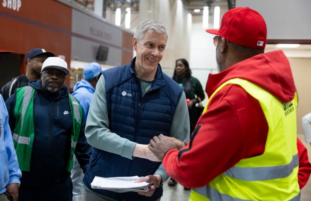 Arne Duncan greets people as community leaders gathered to celebrate a state-funded anti-violence program, April 17, 2025, at the Pullman Community Center. (Brian Cassella/Chicago Tribune)