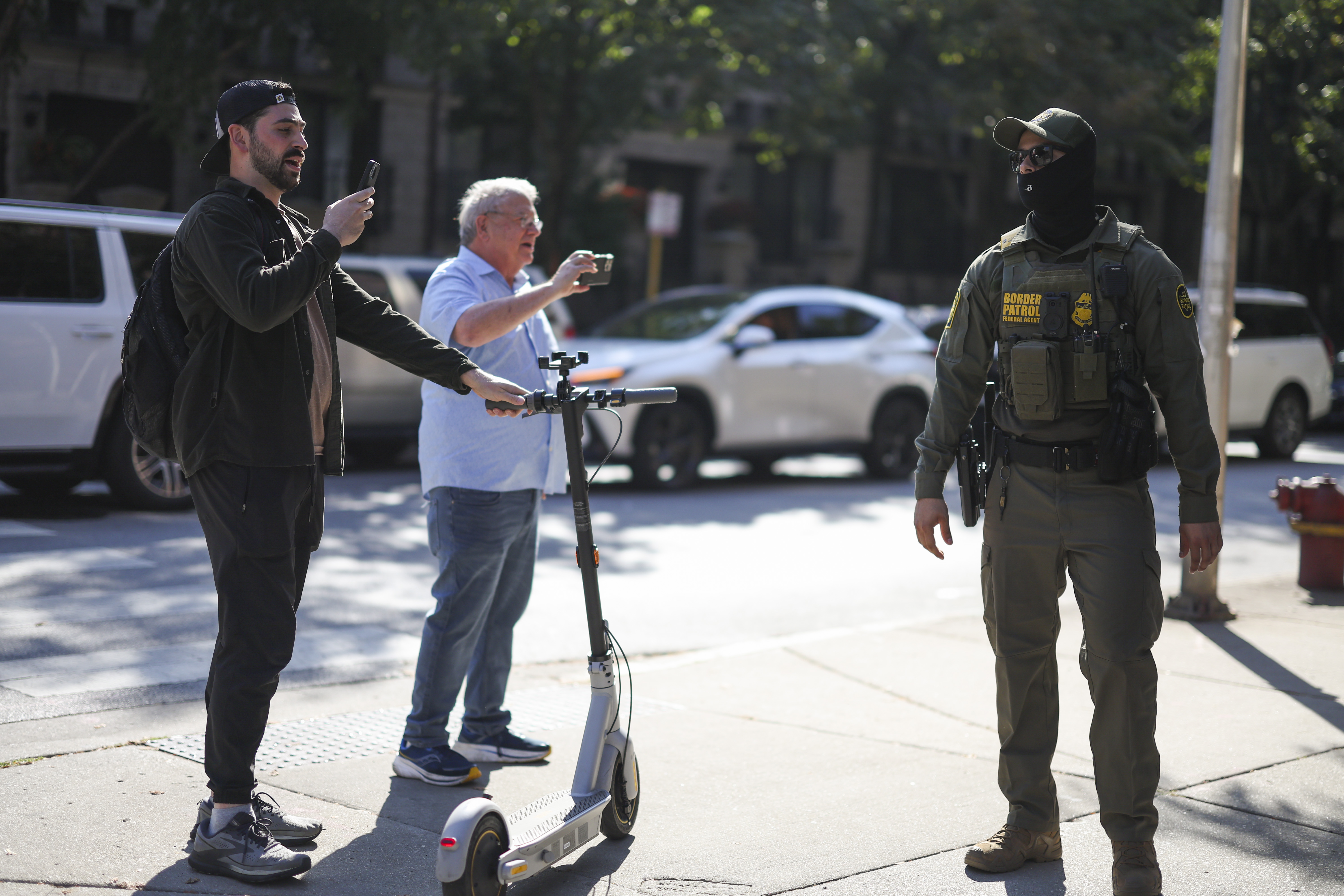 Protesters record U.S. Border Patrol agents at the corner Oak...