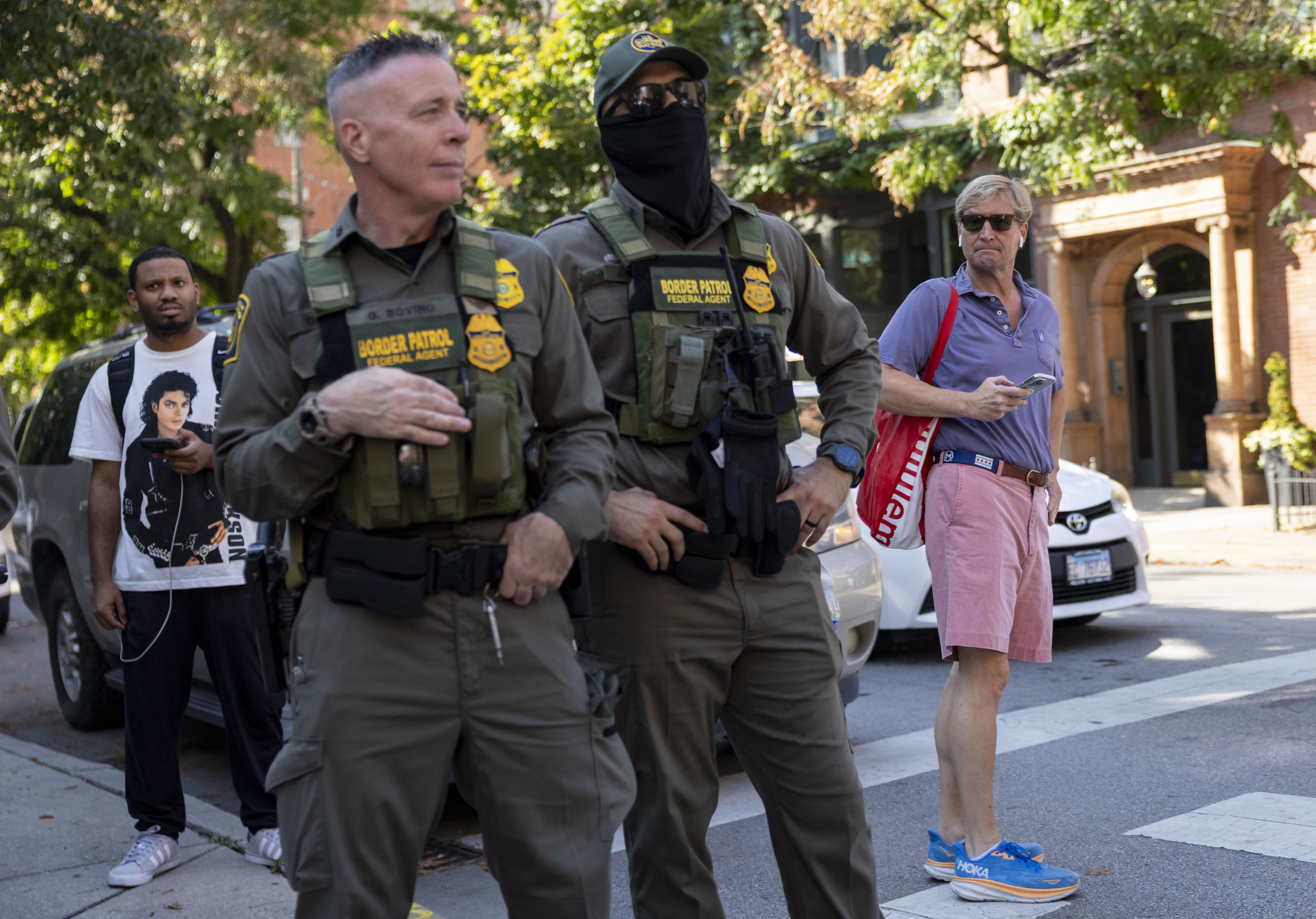 Residents watch while Gregory Bovino,Â chief U.S. Border Patrol agent, second...