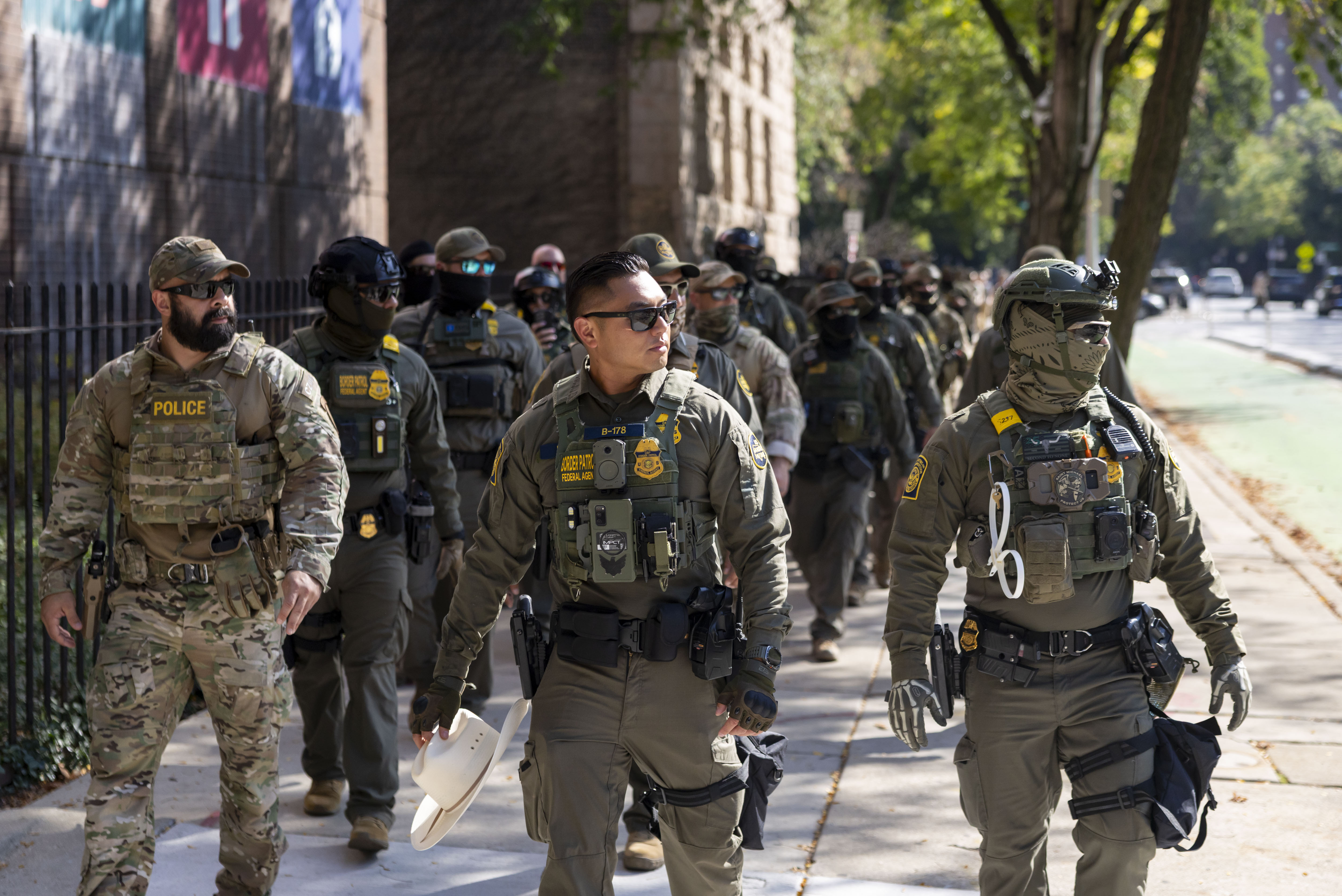 U.S. Border Patrol agents walk along North Clark Street by...