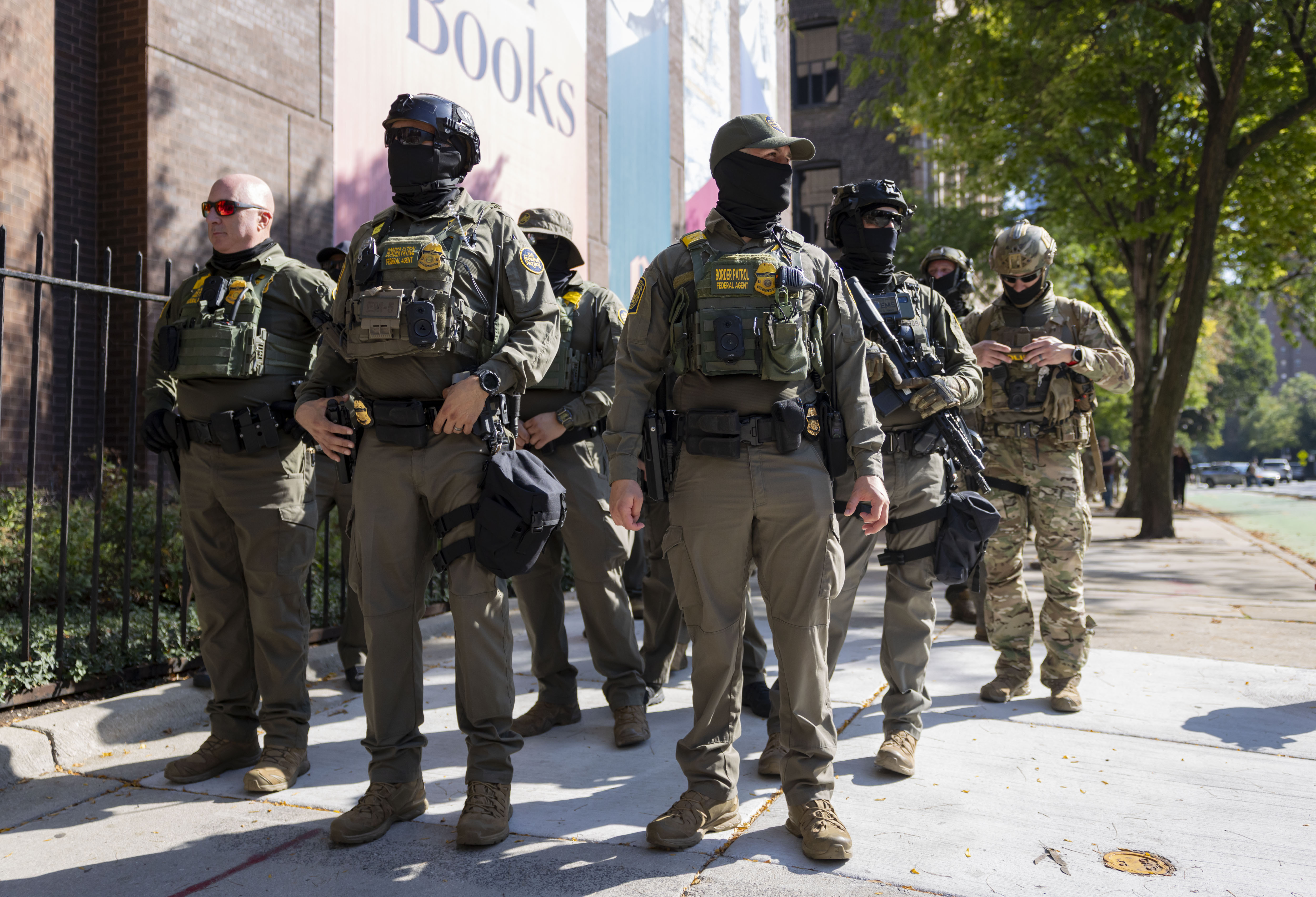 U.S. Border Patrol agents walk along North Clark Street by...
