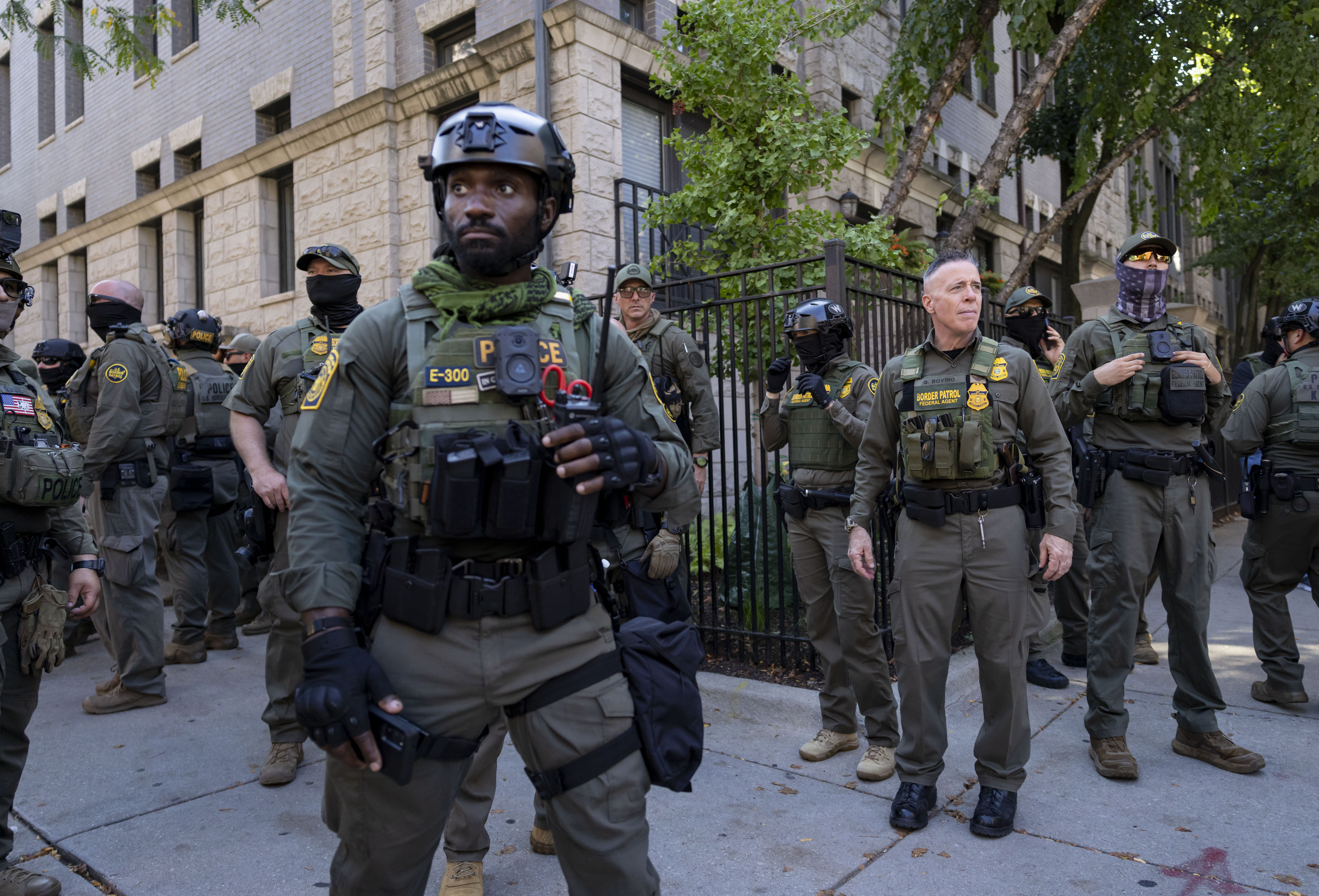 Gregory Bovino, chief U.S. Border agent, stands with other federal...