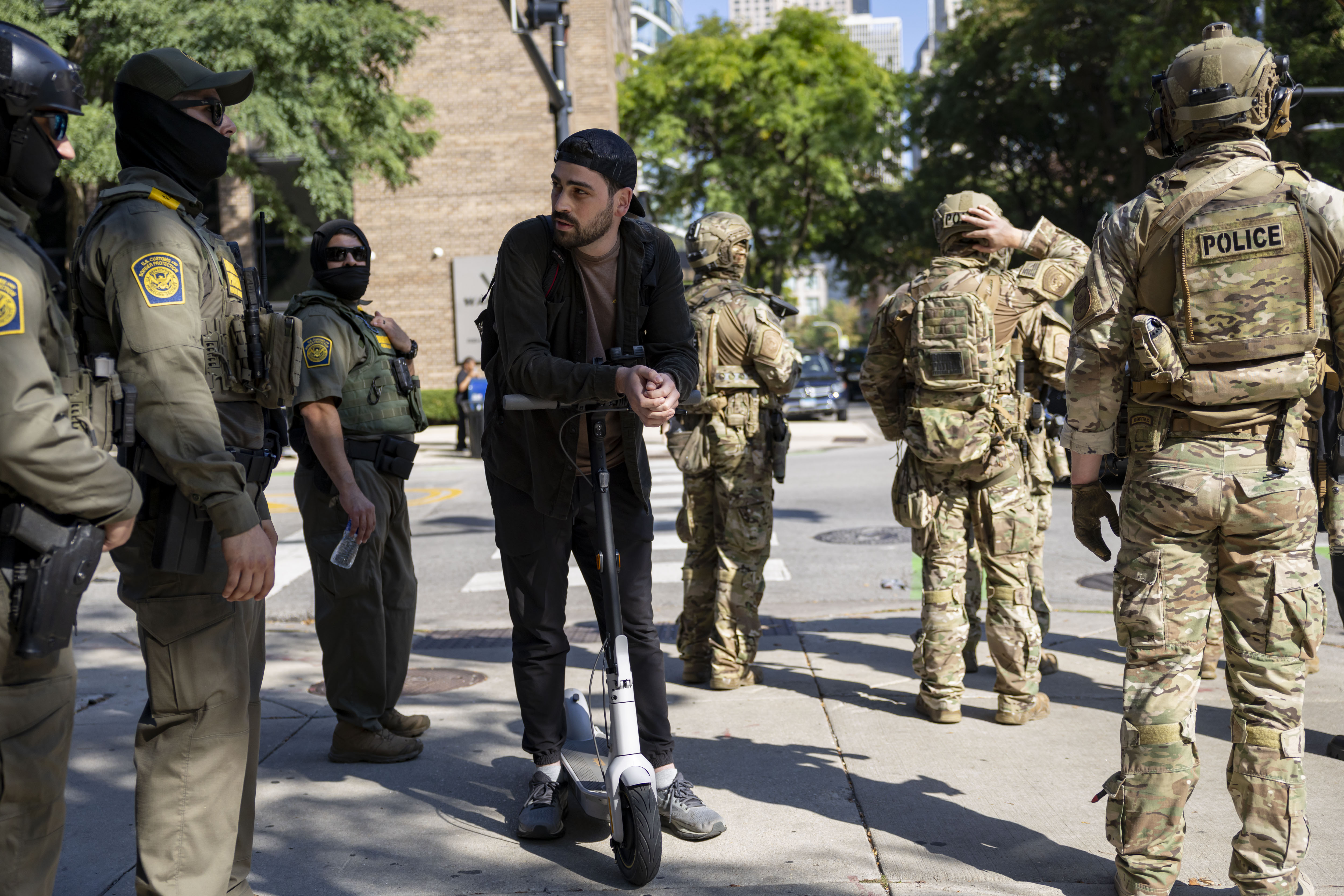 U.S. Border Patrol agents talk to a man on a...