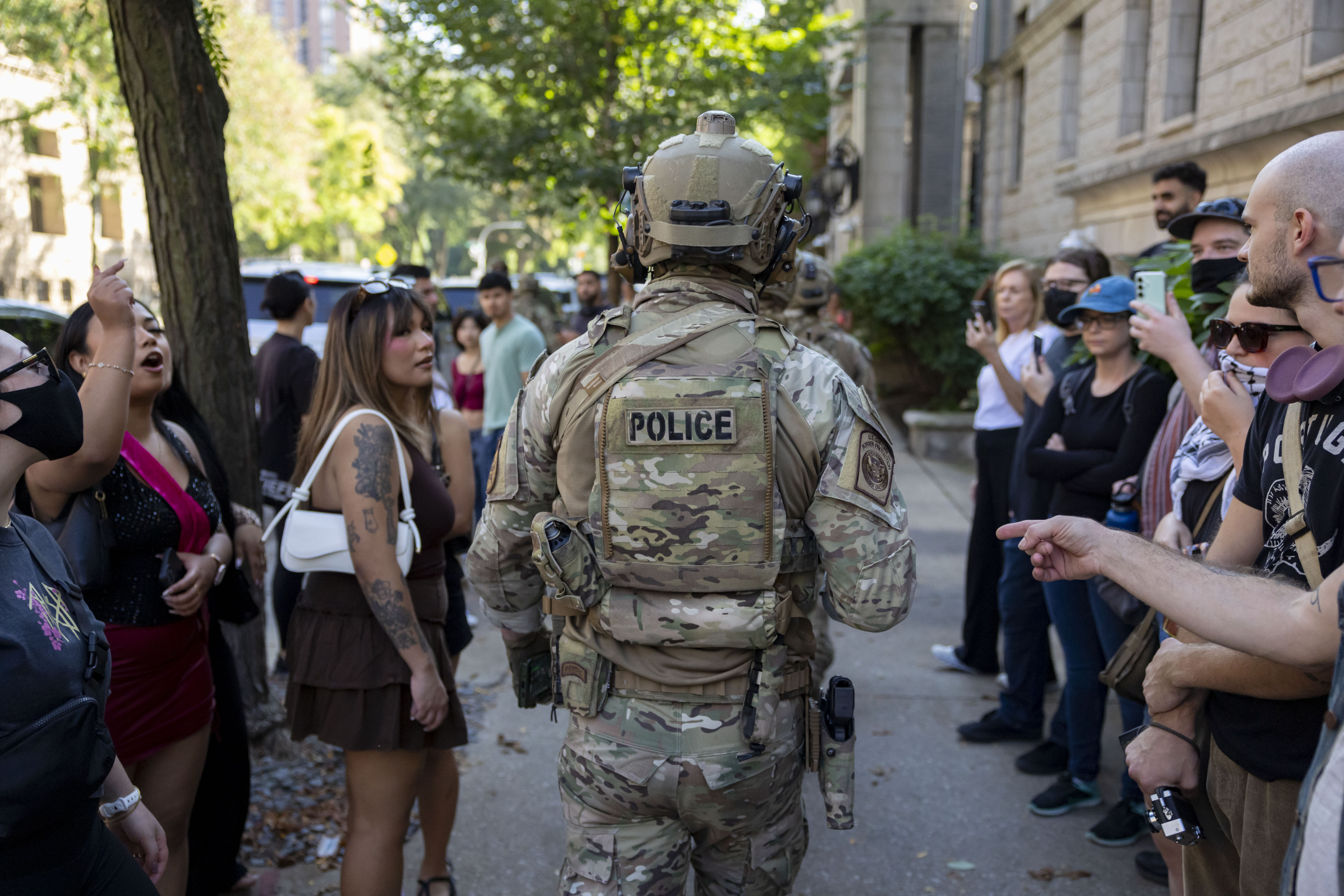People yell at U.S. Border Patrol agents near the Newberry...