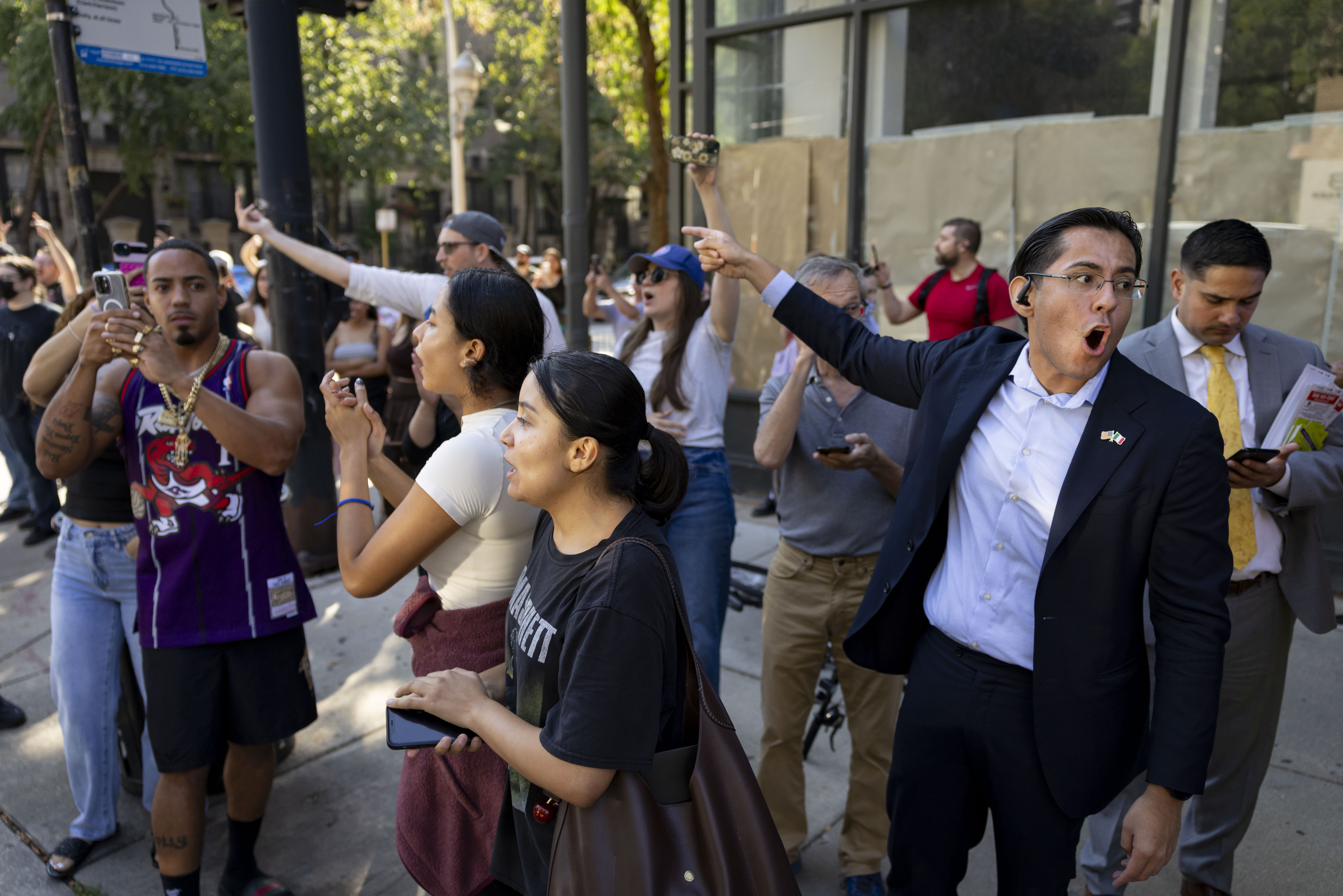 Protesters yell as U.S. Border Patrol agents depart Chicagoâs Gold...