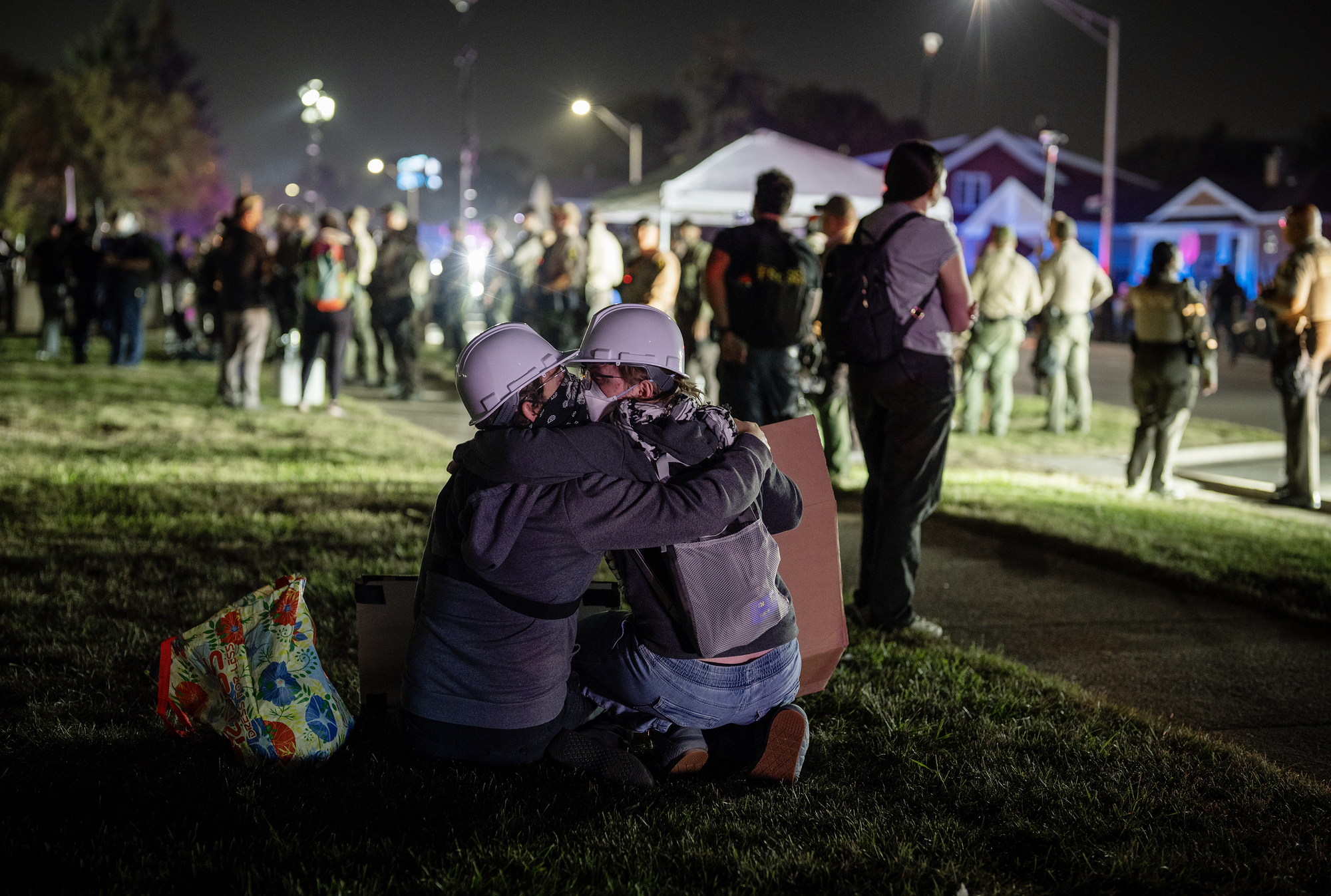 Protesters embrace near the U.S Immigration and Customs Enforcement facility...