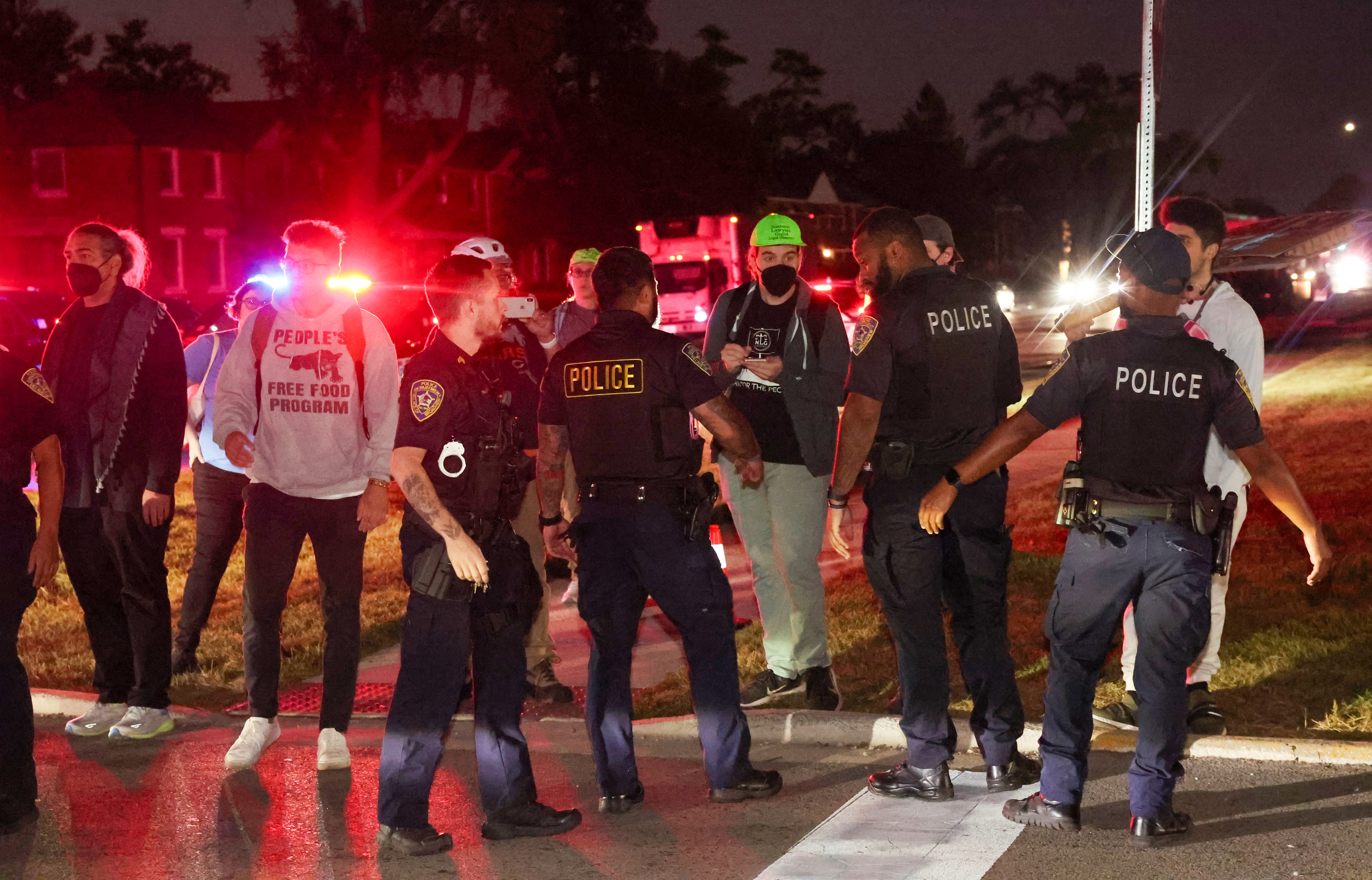 Broadview police hold back protesters from stopping vehicles at Harvard...