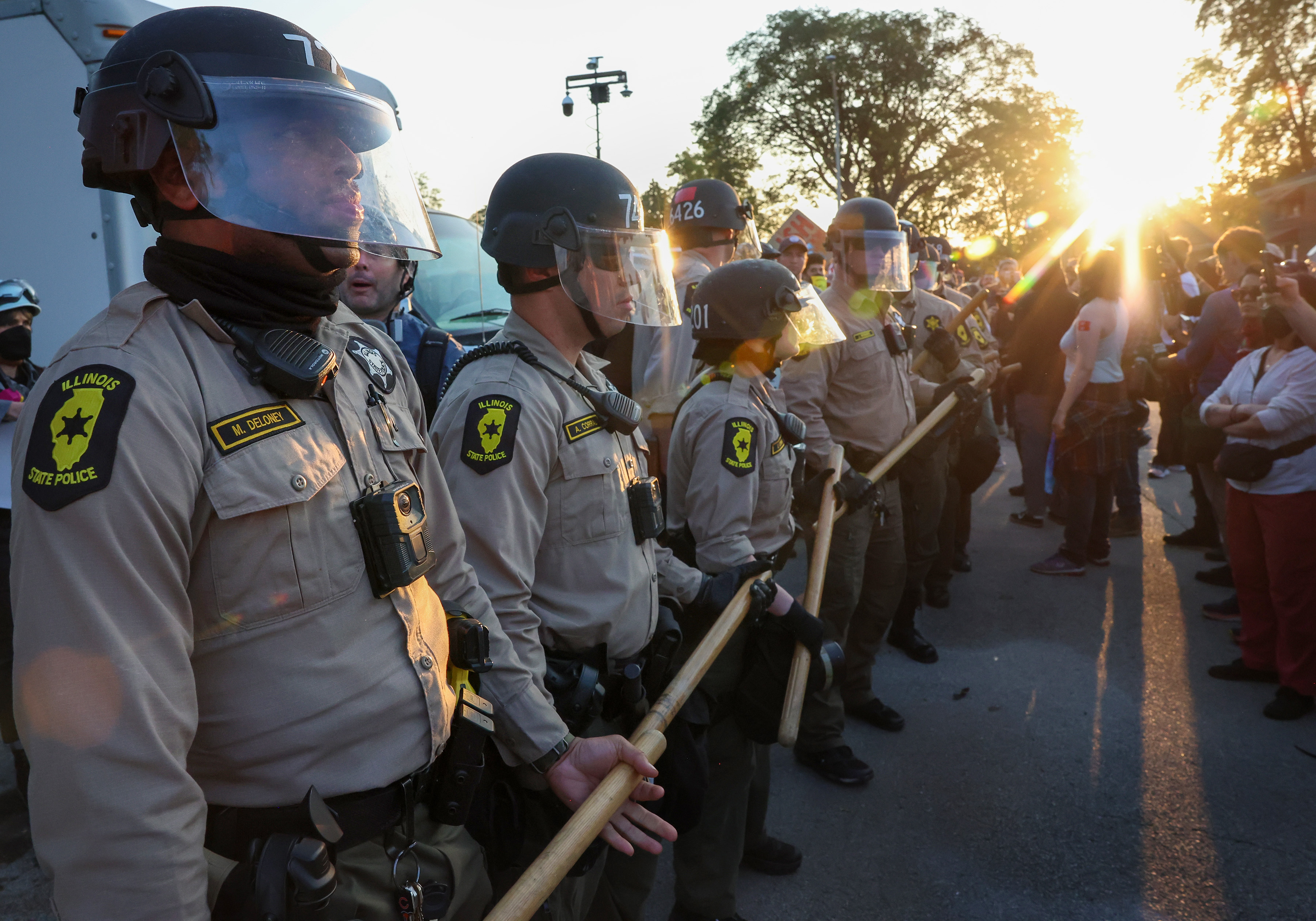 Illinois State Police troopers line up to prevent protesters from...