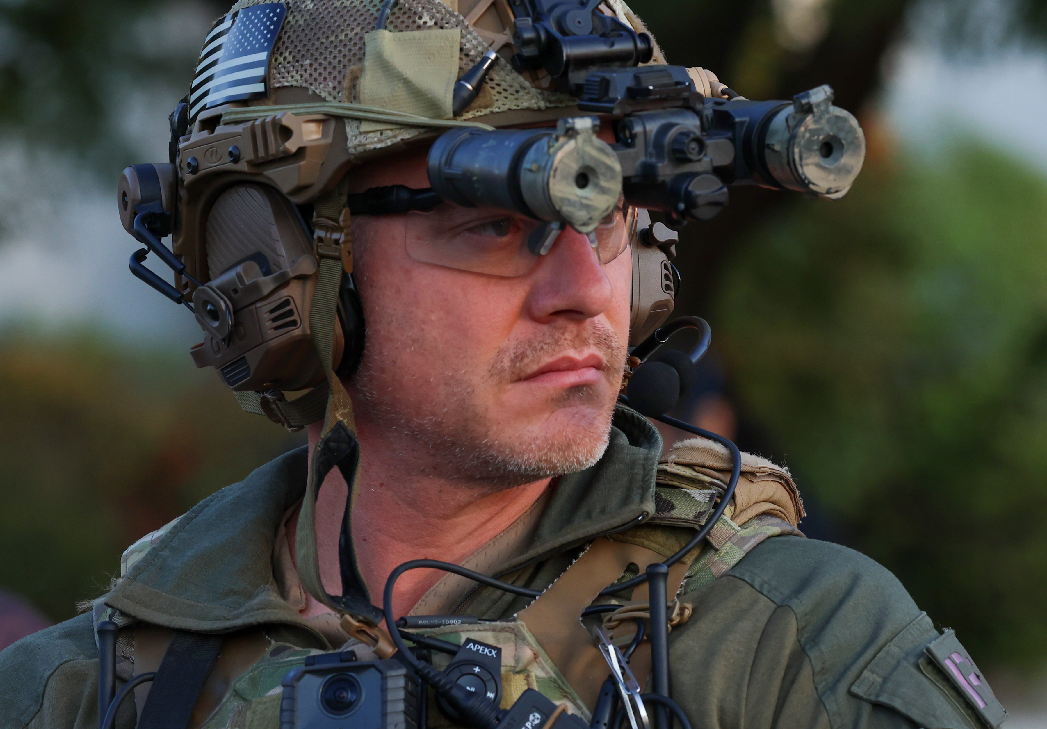 Illinois State Police troopers line up along Harvard Street near...