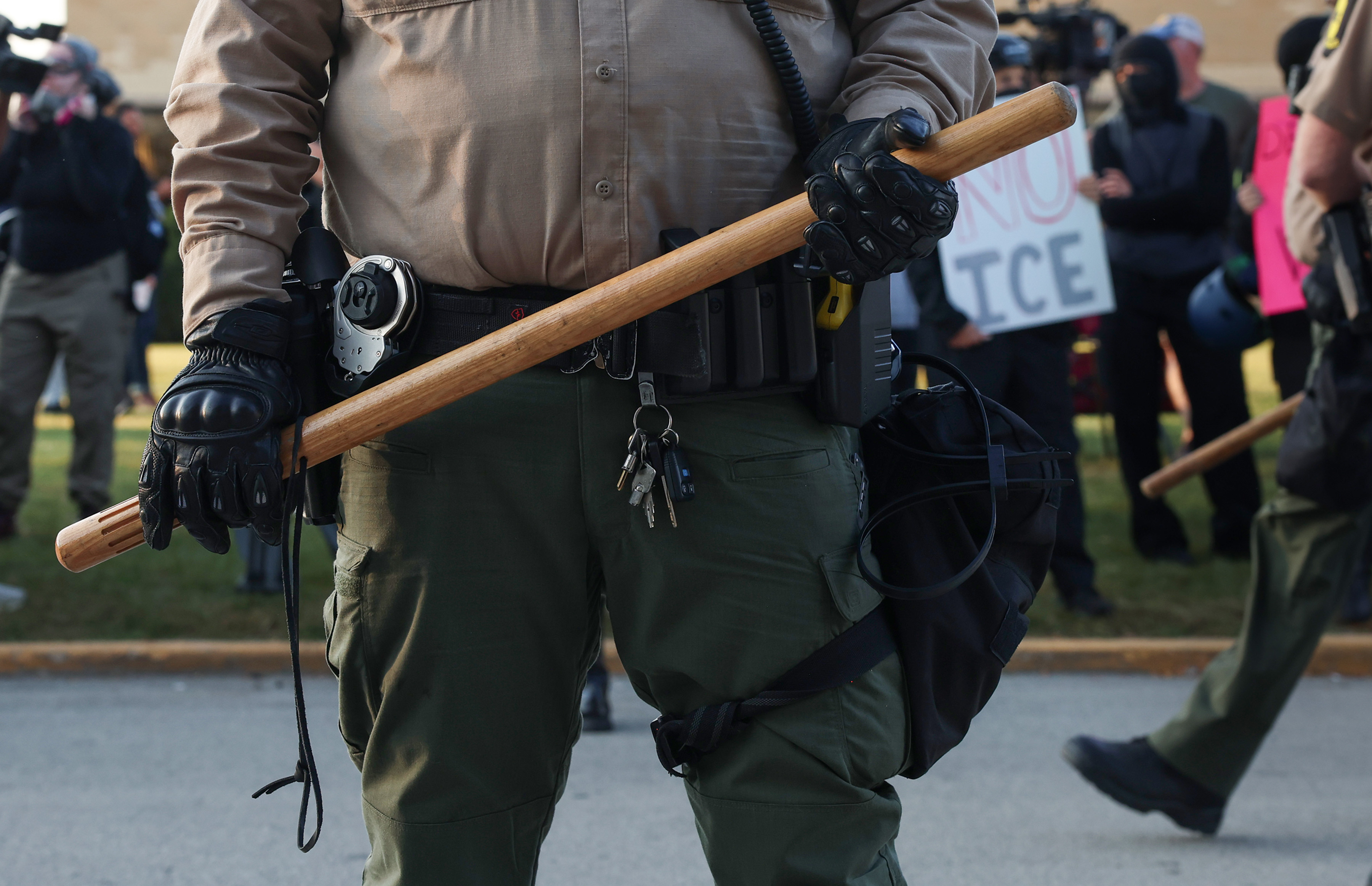 Illinois State Police troopers line up along Harvard Street and...