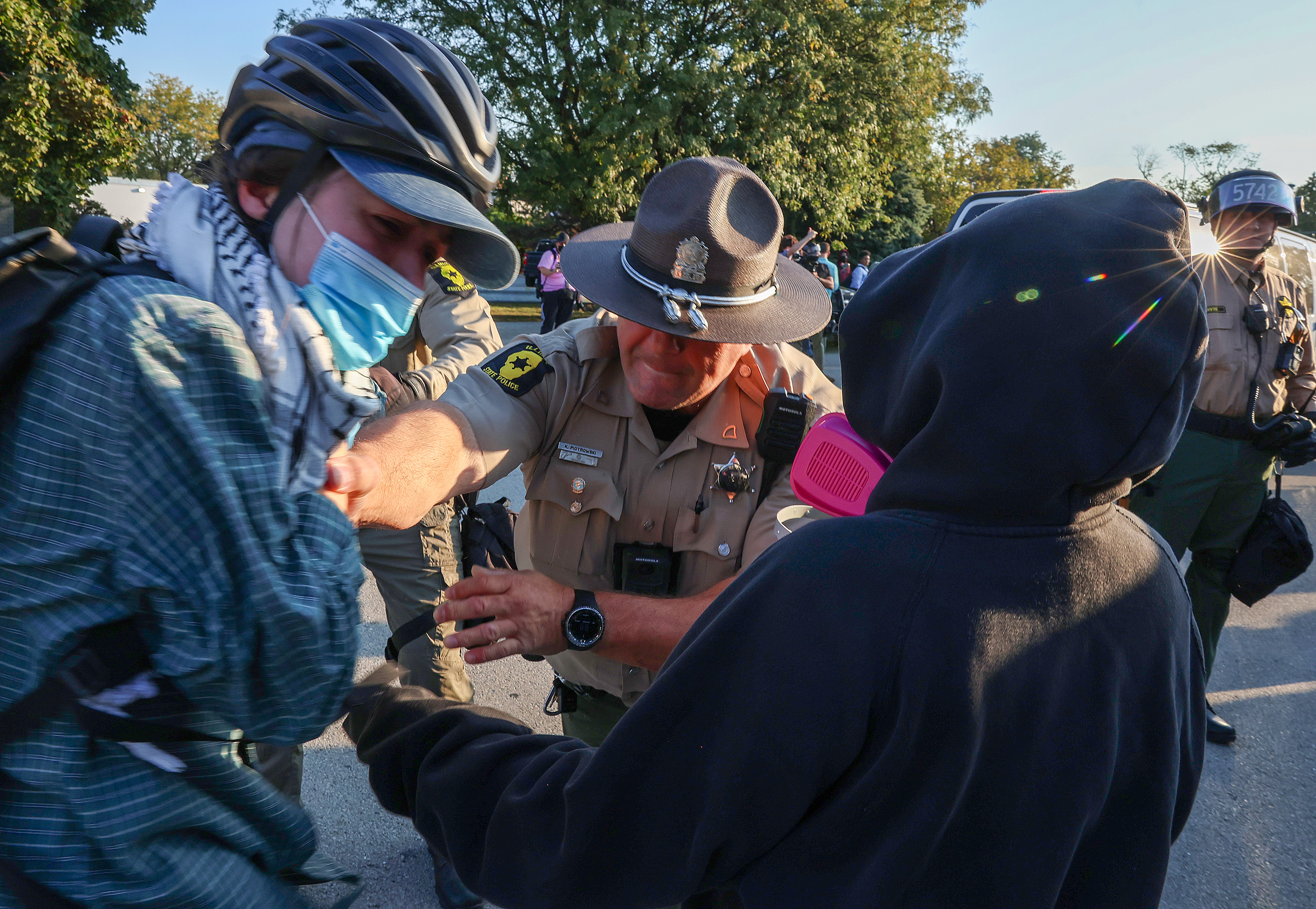 Illinois State Police troopers detain a protester who refused to...