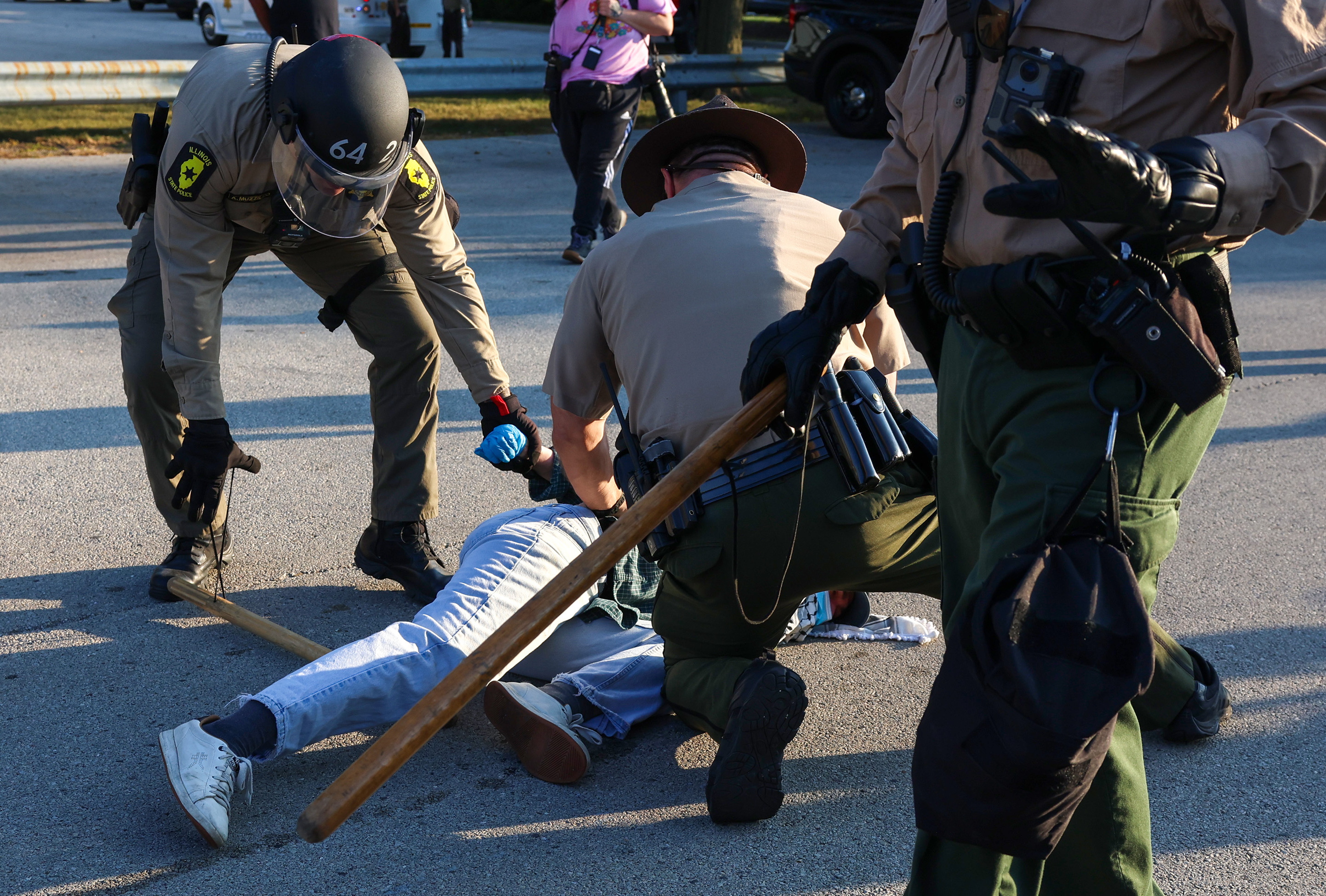 Illinois State Police troopers detain a protester who refused to...