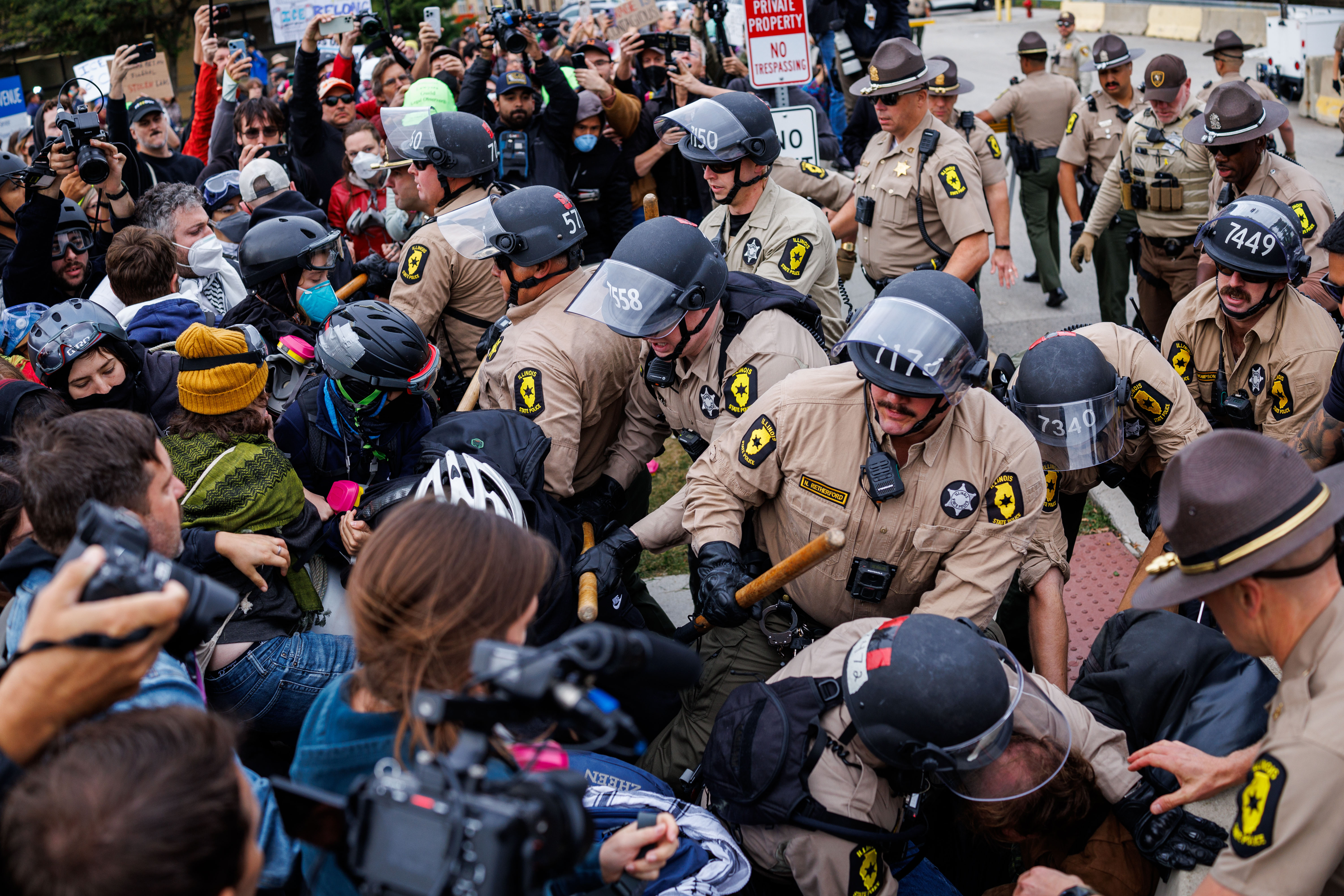 Illinois State Police troopers and Cook County sheriff's deputies push...
