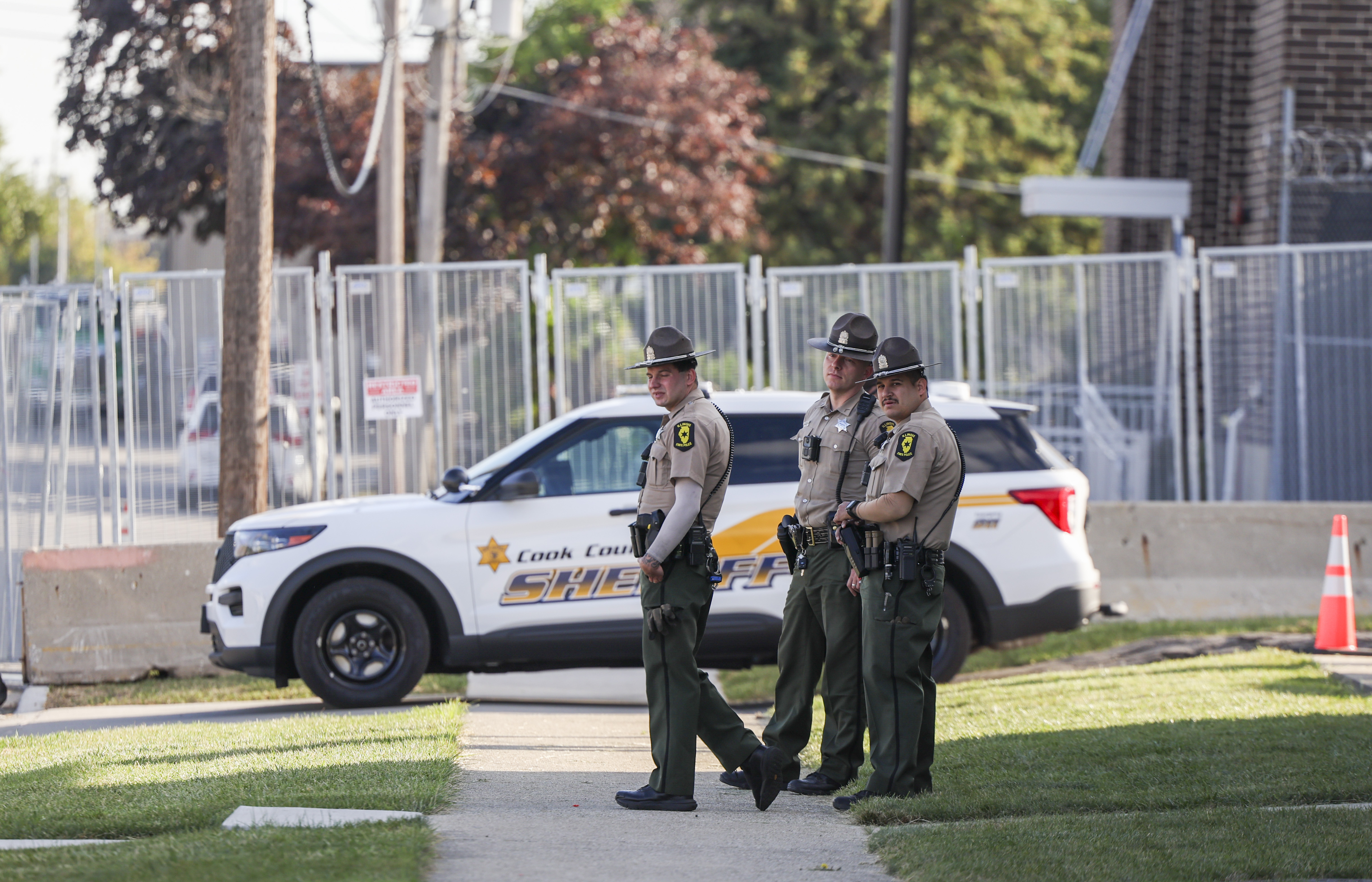 Illinois State Police troopers outside the U.S. Immigration and Customs...