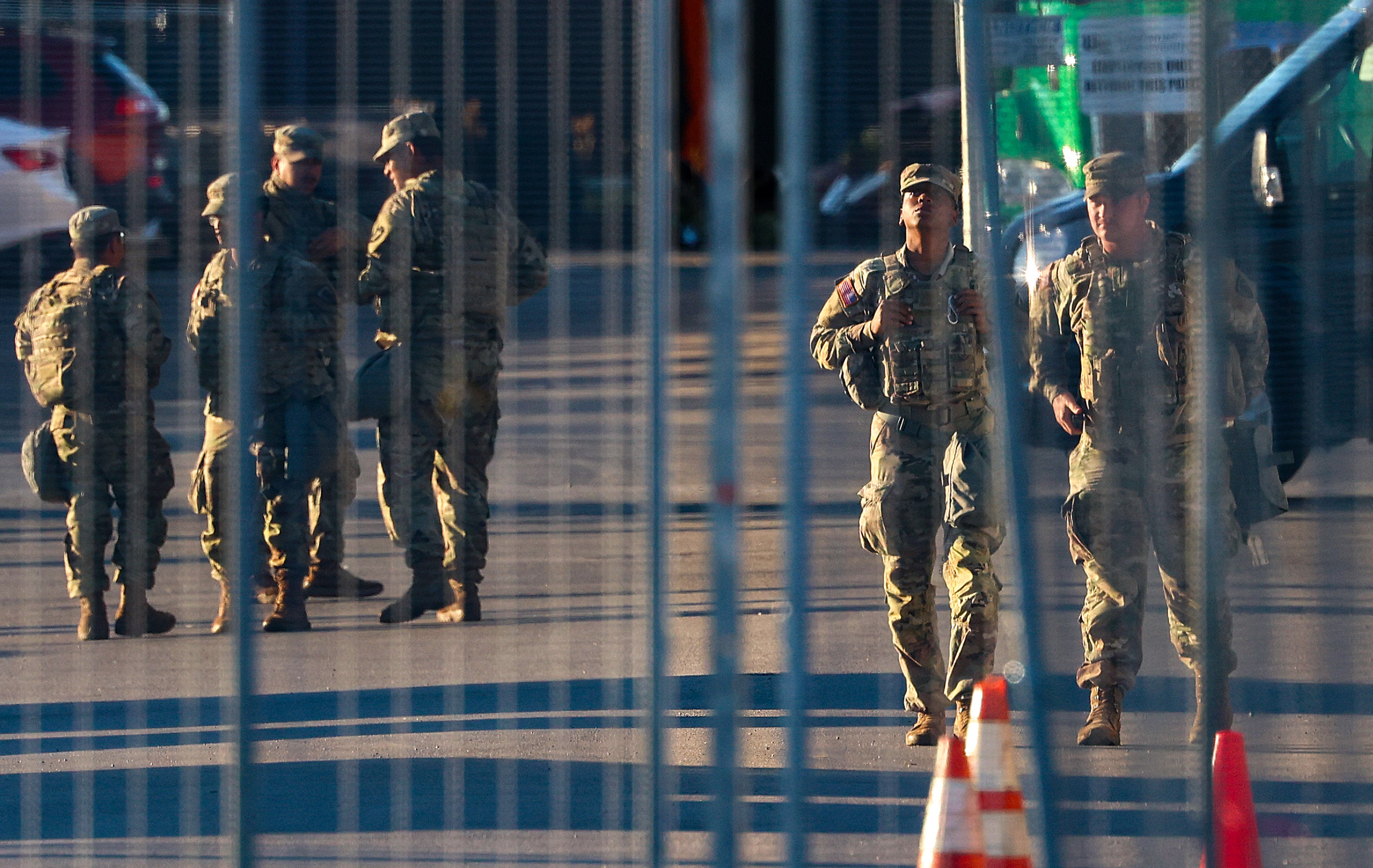 National Guard members walk around outside of the U.S. Immigration...