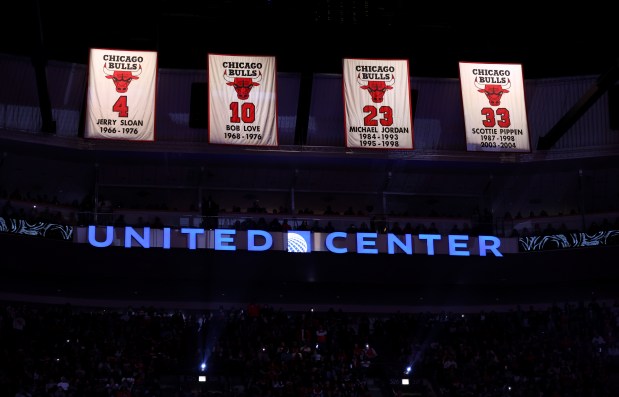 The numbers of Chicago Bulls greats Jerry Sloan, Bob Love, Michael Jordan and Scottie Pippen are seen hanging above the United Center flooron Jan. 4, 2025. Derrick Rose's No. 1 jersey will be retired in January 2026. (Chris Sweda/Chicago Tribune)