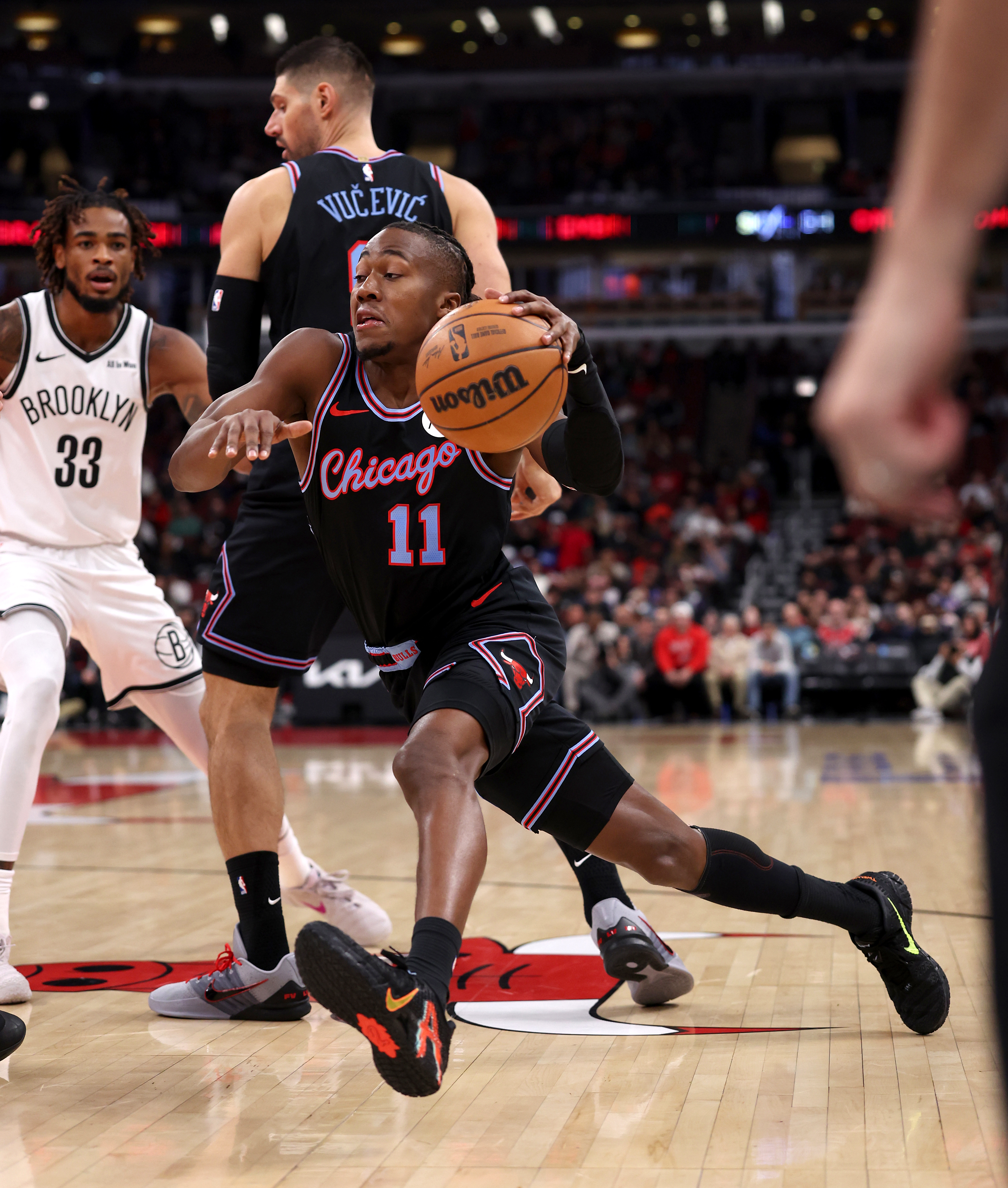 Chicago Bulls guard Ayo Dosunmu (11) drives to the hoop in the first half of a game against the Brooklyn Nets at the United Center in Chicago on Dec. 3, 2025. (Chris Sweda/Chicago Tribune)