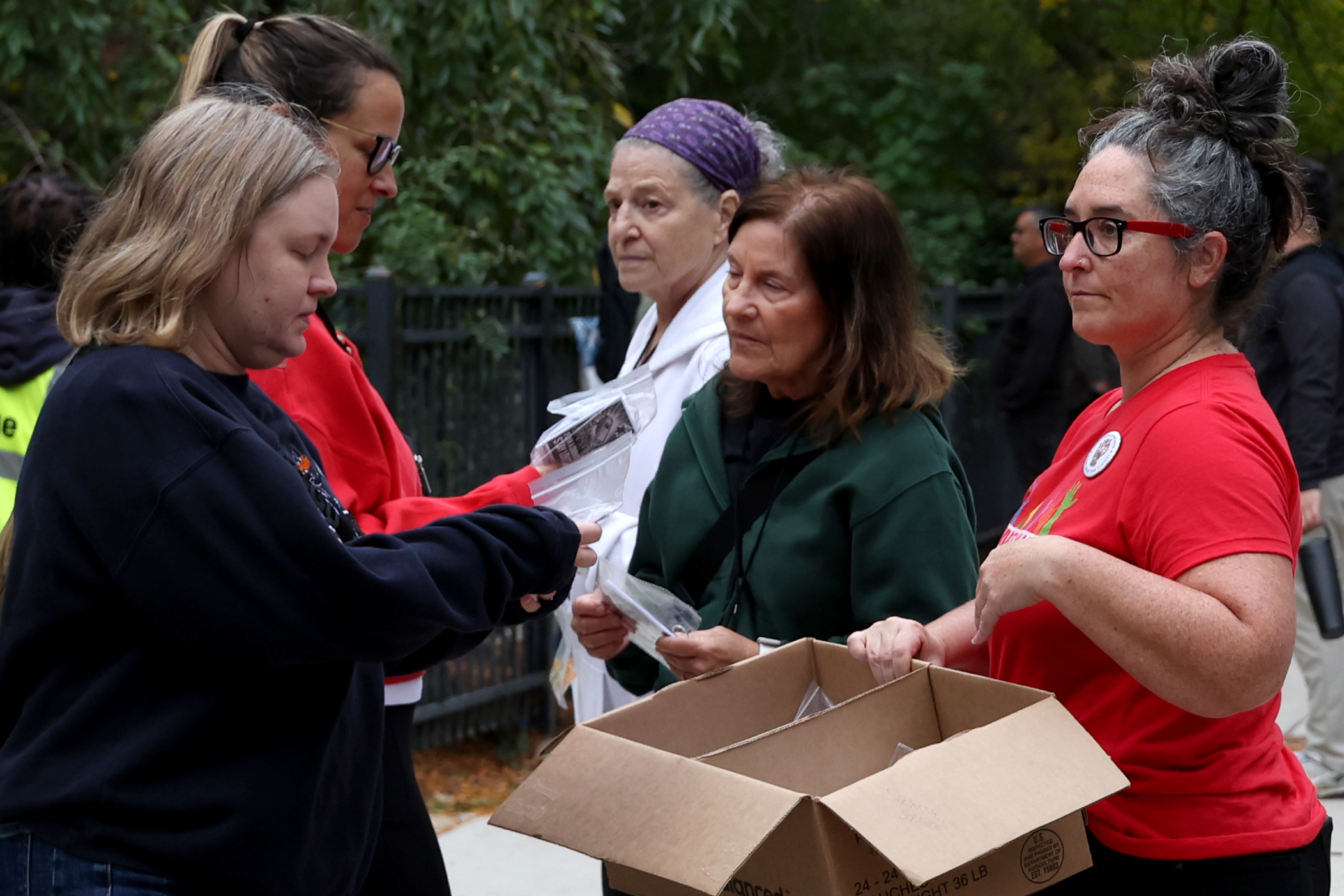 Informational booklets and whistles are handed out outside Chappell Elementary...