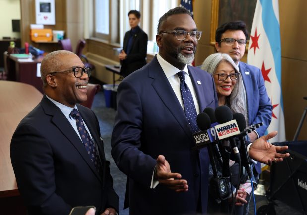 Chicago Mayor Brandon Johnson, second from left, talks to reporters after a City Council meeting on May 7, 2025. With Johnson are Ald. Walter Burnett, 27th, from left, Mayor Johnnson, Ald. Leni Manaa-Hoppenworth, 48th, and Ald. Byron Sigcho-Lopez, 25th. (Terrence Antonio James/Chicago Tribune)
