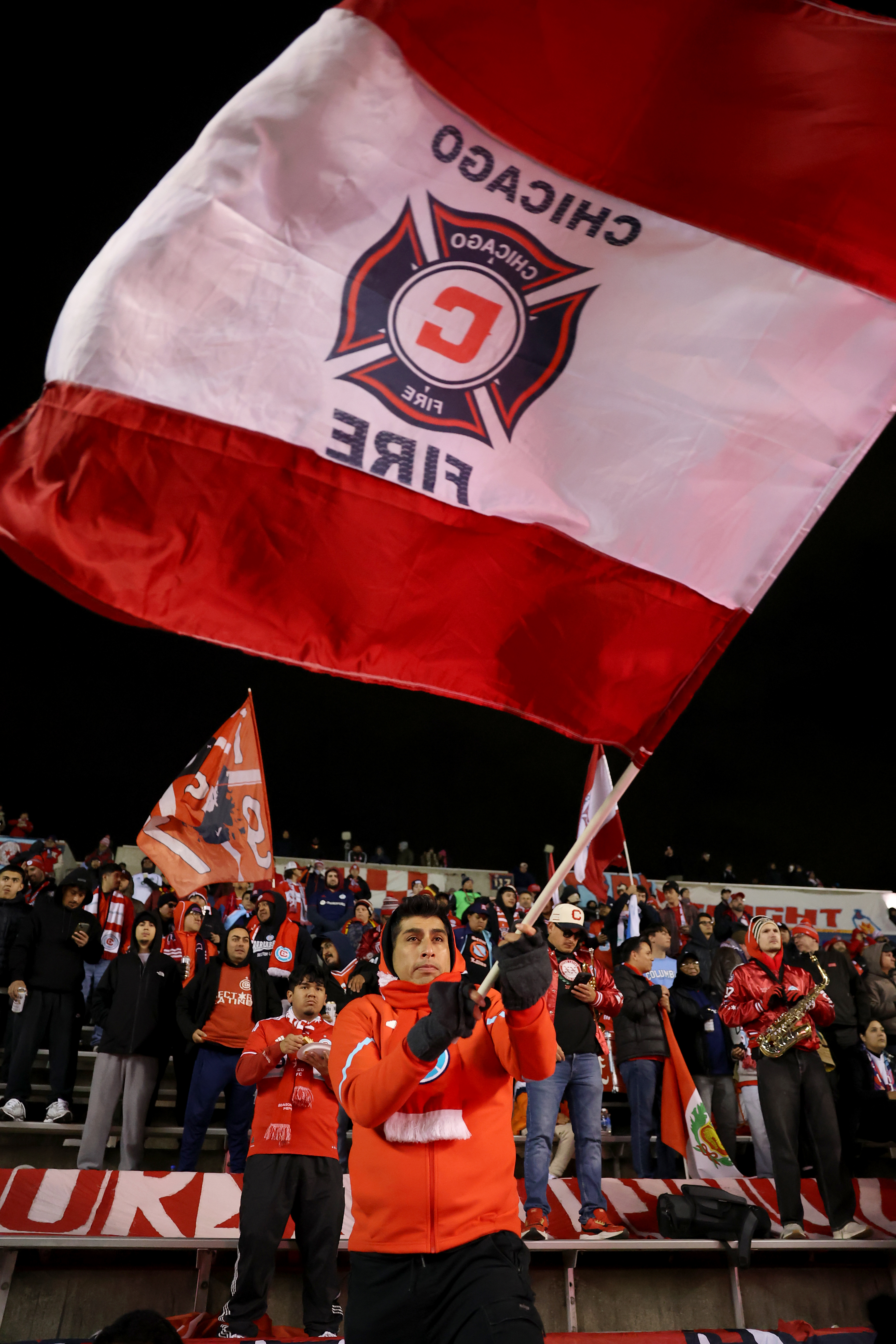 A fan waves an oversized Chicago Fire flag before the...