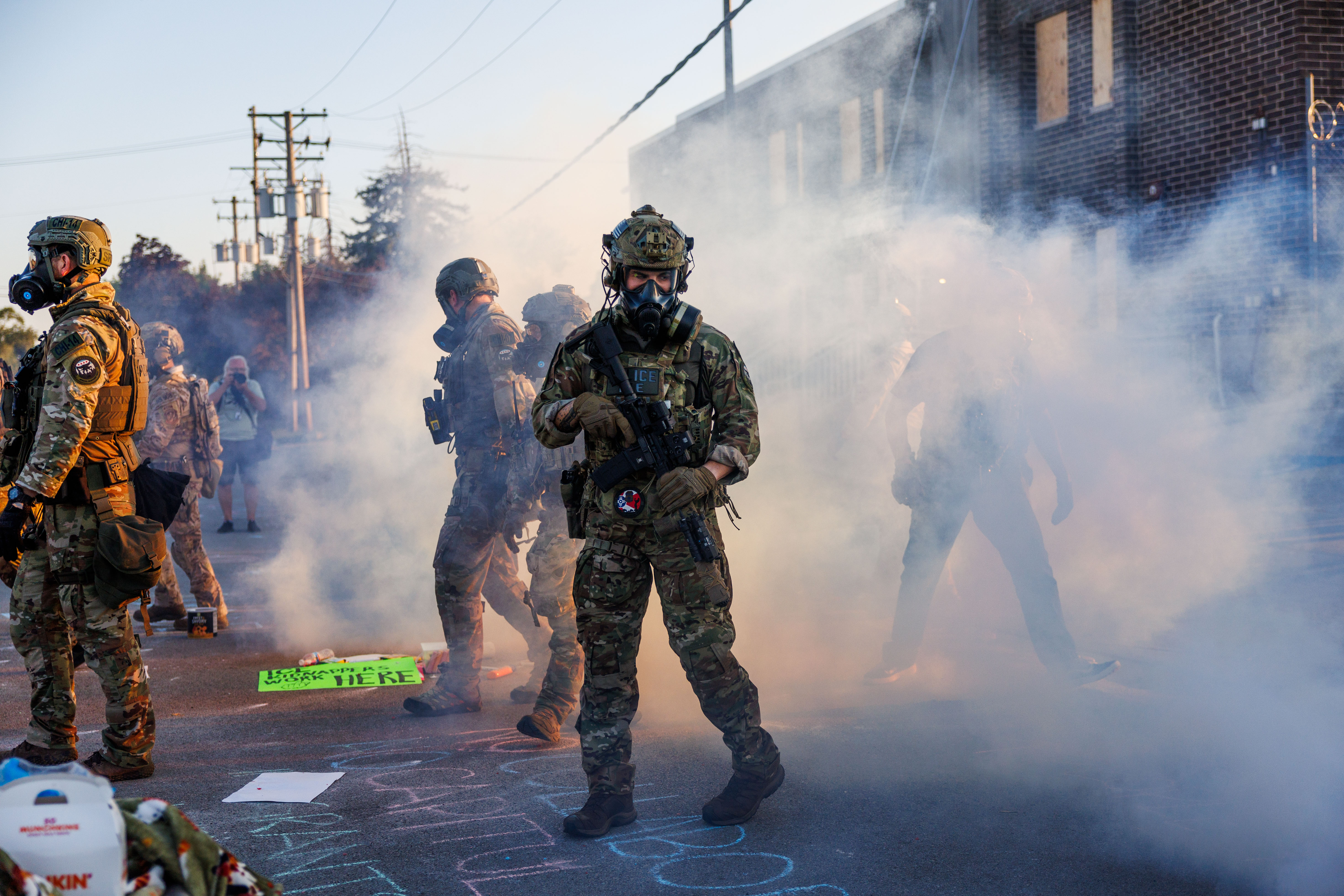 Federal agents attempt to clear protesters from the street to...