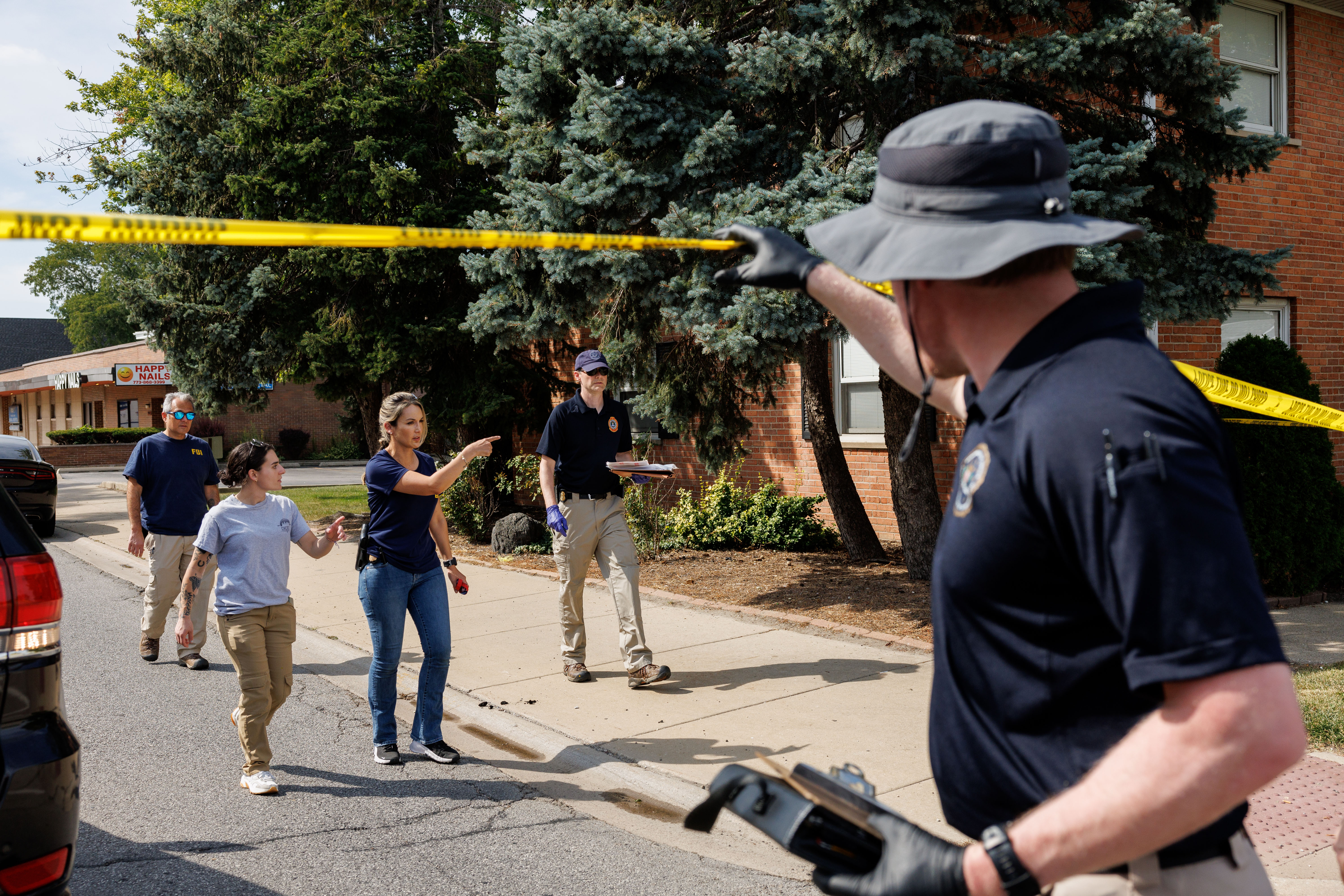 Federal Bureau of Investigation and other law enforcement officers investigate...