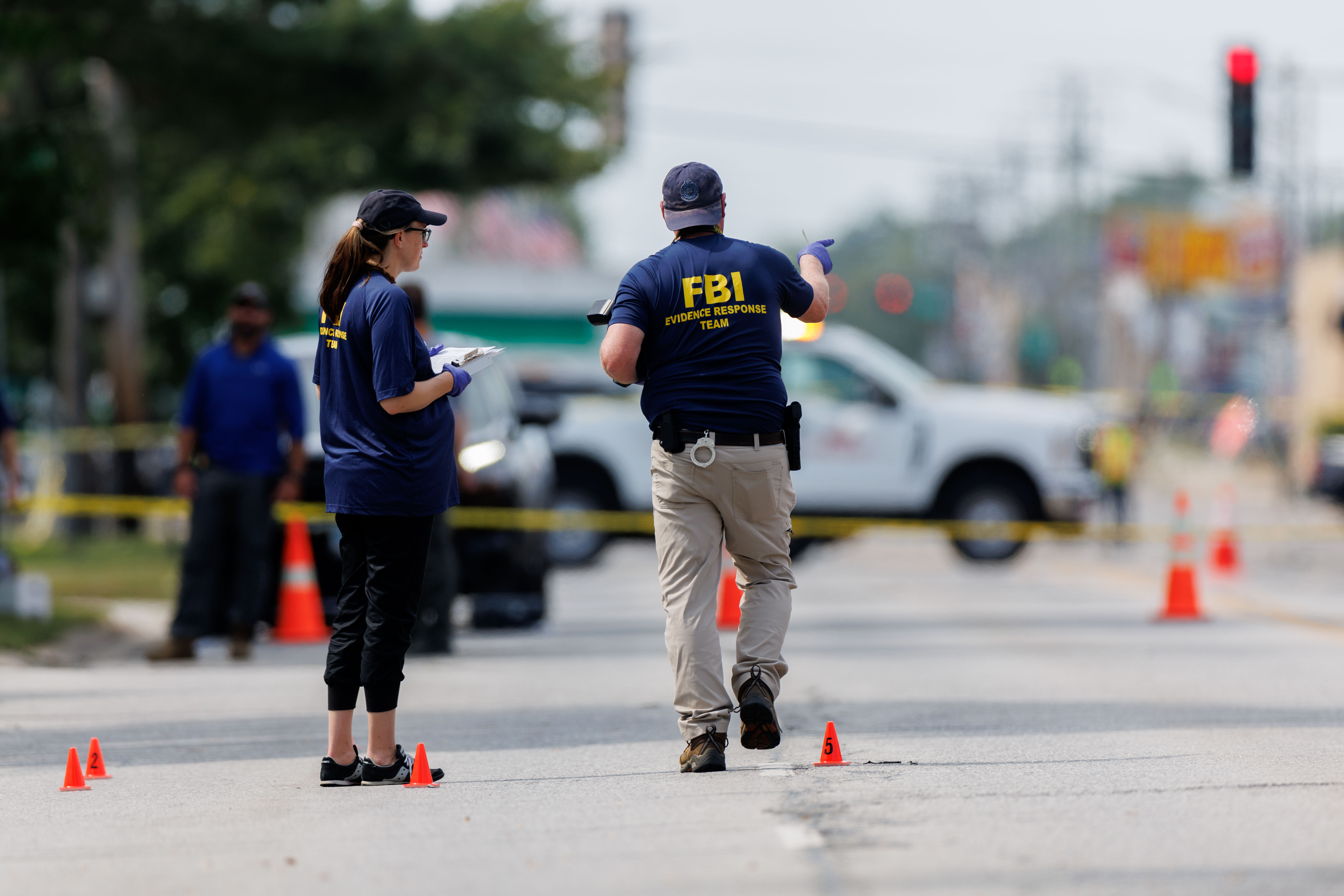 FBI and other law enforcement officers investigate at the scene...