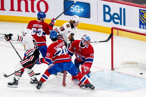 Blackhawks forward Frank Nazar (91) scores against Canadiens goaltender Jakub Dobes, right, during the first period Thursday, Dec. 18, 2025, in Montreal. (Christopher Katsarov/The Canadian Press via AP)