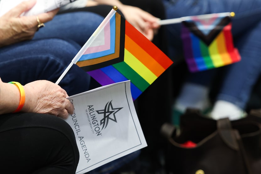 Attendees hold Pride flags during a City Council meeting on Tuesday, Dec. 9, 2025, in...