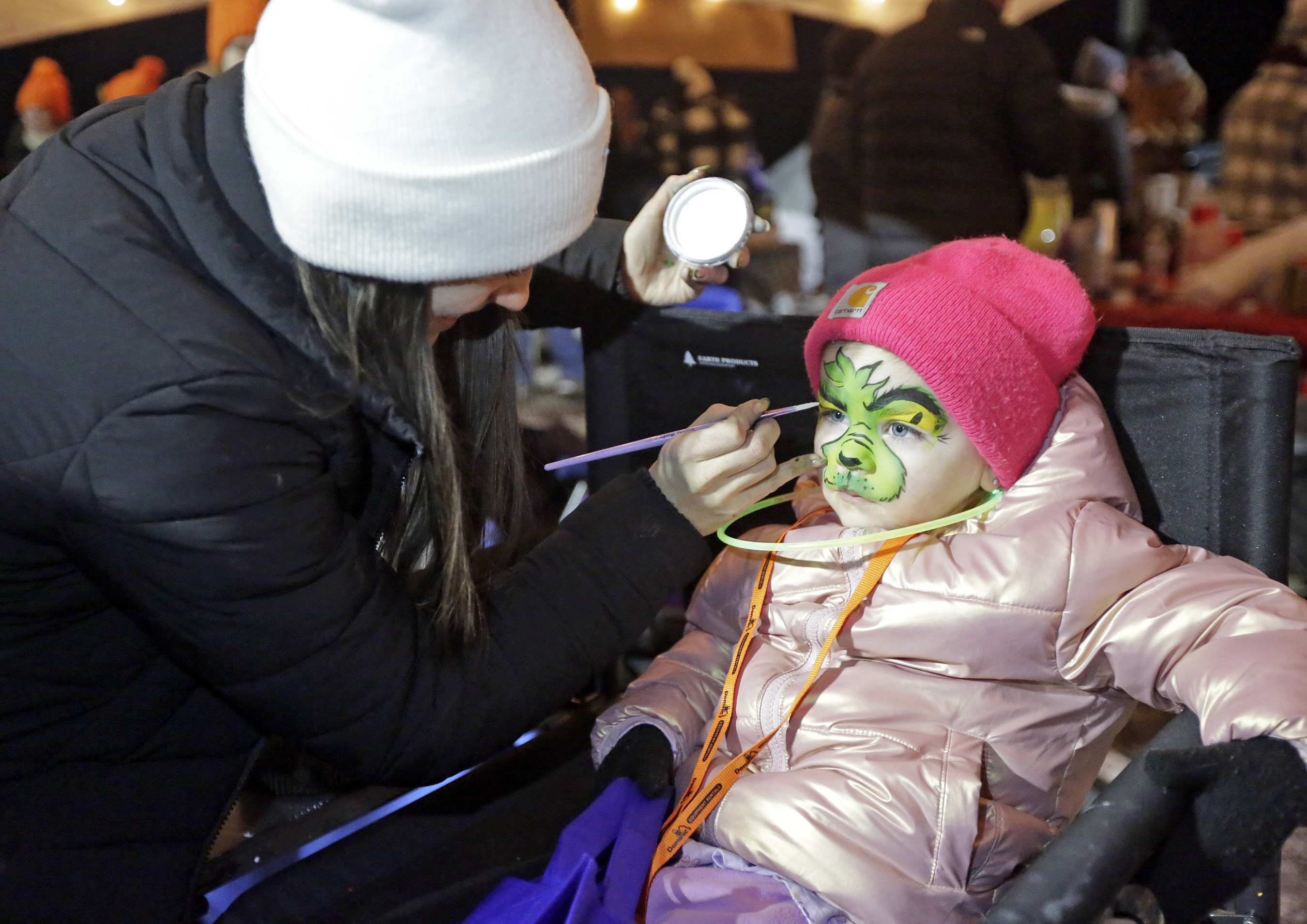 Two-year-old McKinley Trull, of Dallas, has her face painted like...
