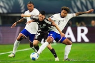 Mexico forward Hirving Lozano (22) is defended by United States midfielder Weston Mckennie...
