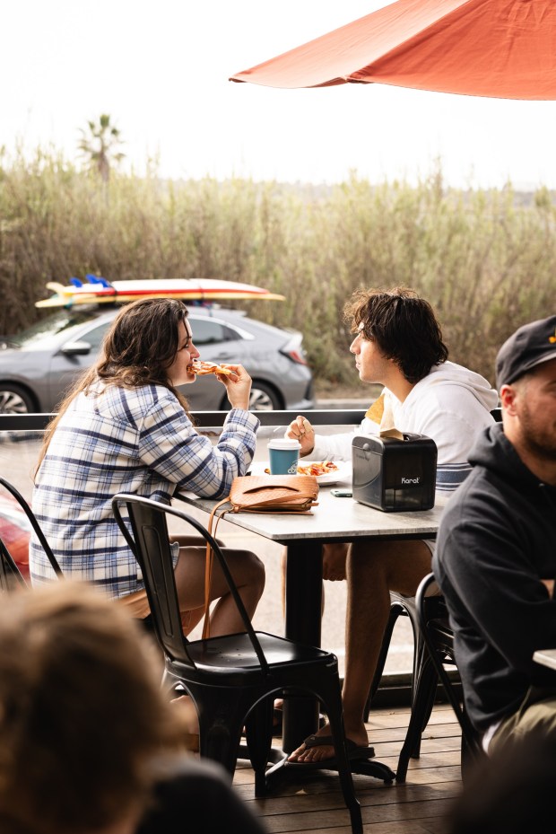 Guests enjoy pizza at Buonasera Del Mar, which will host "The Grinch Serves Christmas" pop-up. (Courtesy Buonasera)