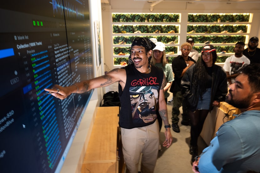 Brandon Blue, 39, a DJ and music producer, points toward a playlist on the DJ program...