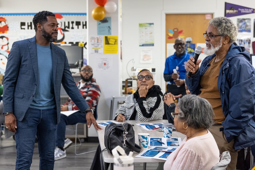 Dallas ISD trustee Byron Sanders listens to a question from L.G. Pinkston Class of 1969...