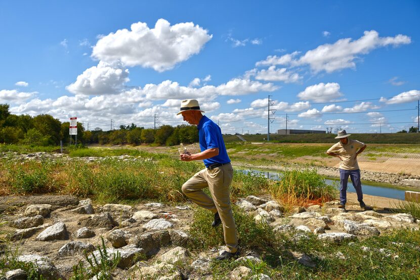 Garrett Boone carries litter he calls a "Trinity River cocktail" collected during his walk...