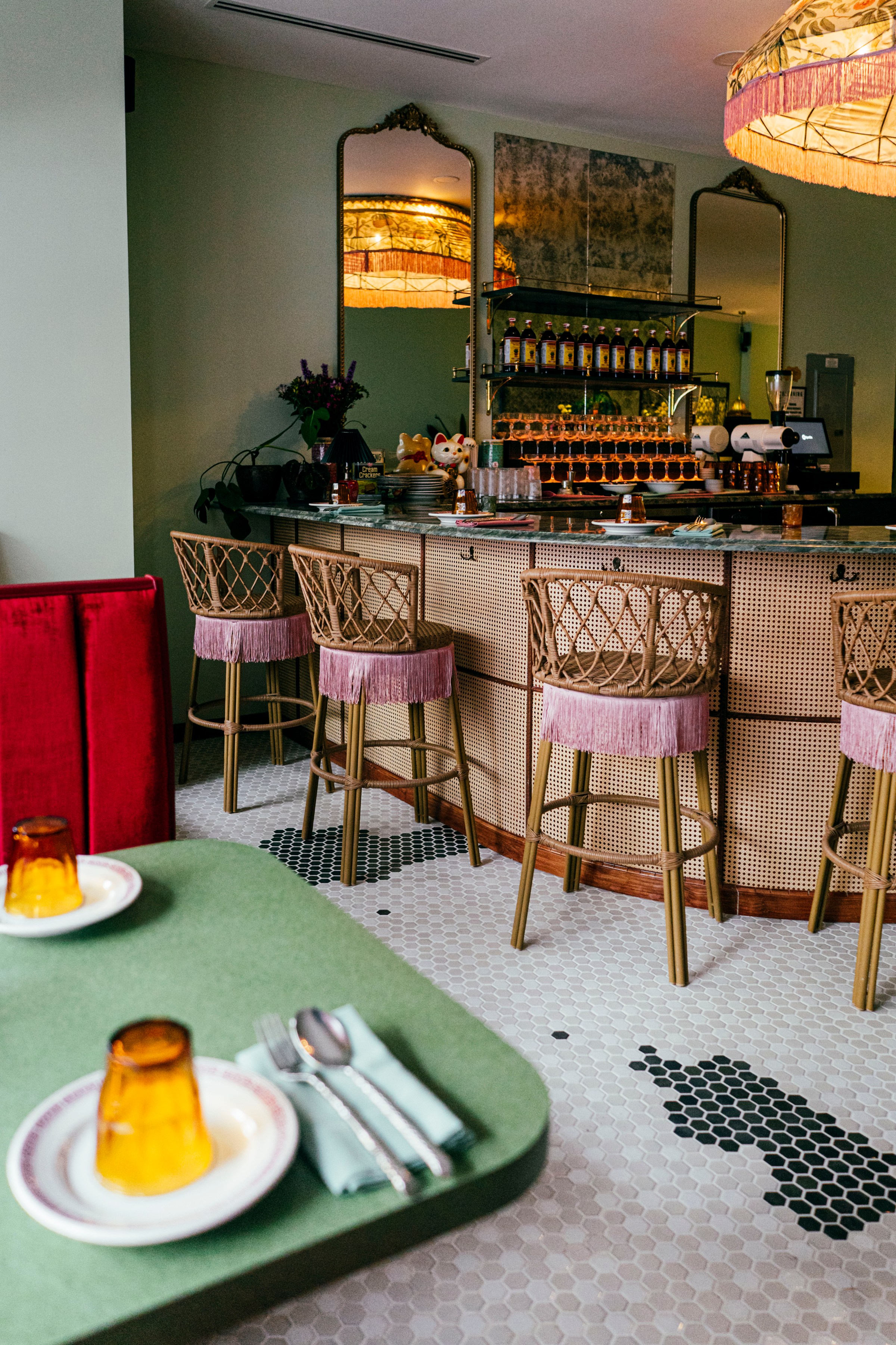 A restaurant dining room with a table in front of a bar.