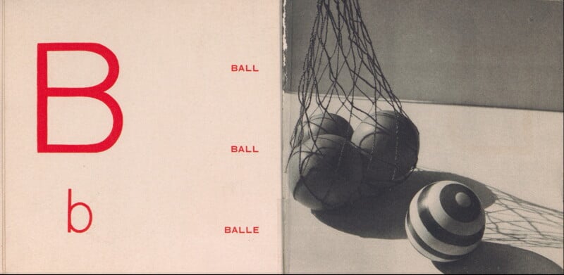 A large red letter "B" and lowercase "b" appear on the left side with the word "ball" written in English and French. On the right, four balls, including a striped one, sit on a surface inside a net.