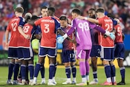 FC Dallas players including (from left) Christian Cappis (12), defender Shaq Moore (18),...