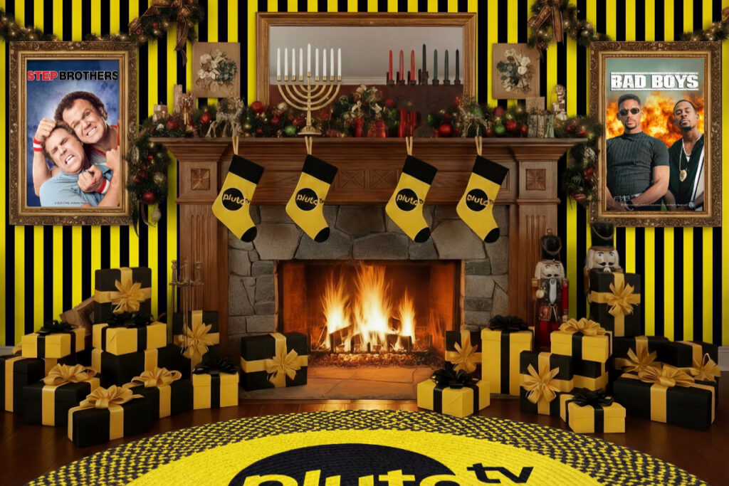 Image shows a classic Christmas room with various holiday decor including a fireplace, stockings, and candleabras for the Pluto TV Christmas rage room experience in Houston.