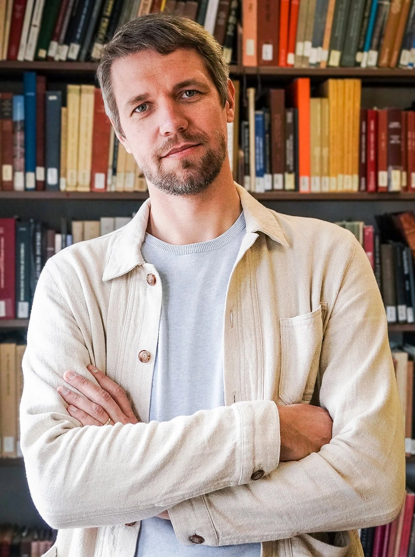 Image may contain Book Indoors Library Publication Adult Person Furniture Bookcase Face and Head