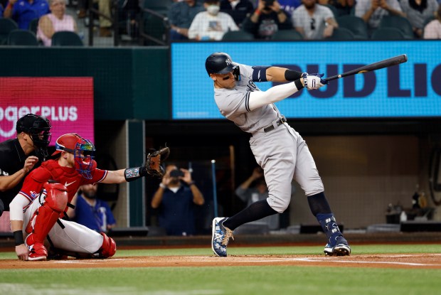 ARLINGTON, TX - OCTOBER 4: Aaron Judge #99 of the New York Yankees hits his 62nd home run of the season against the Texas Rangers during the first inning in game two of a double header at Globe Life Field on October 4, 2022 in Arlington, Texas. Judge has now set the American League record for home runs in a single season. (Photo by Ron Jenkins/Getty Images)