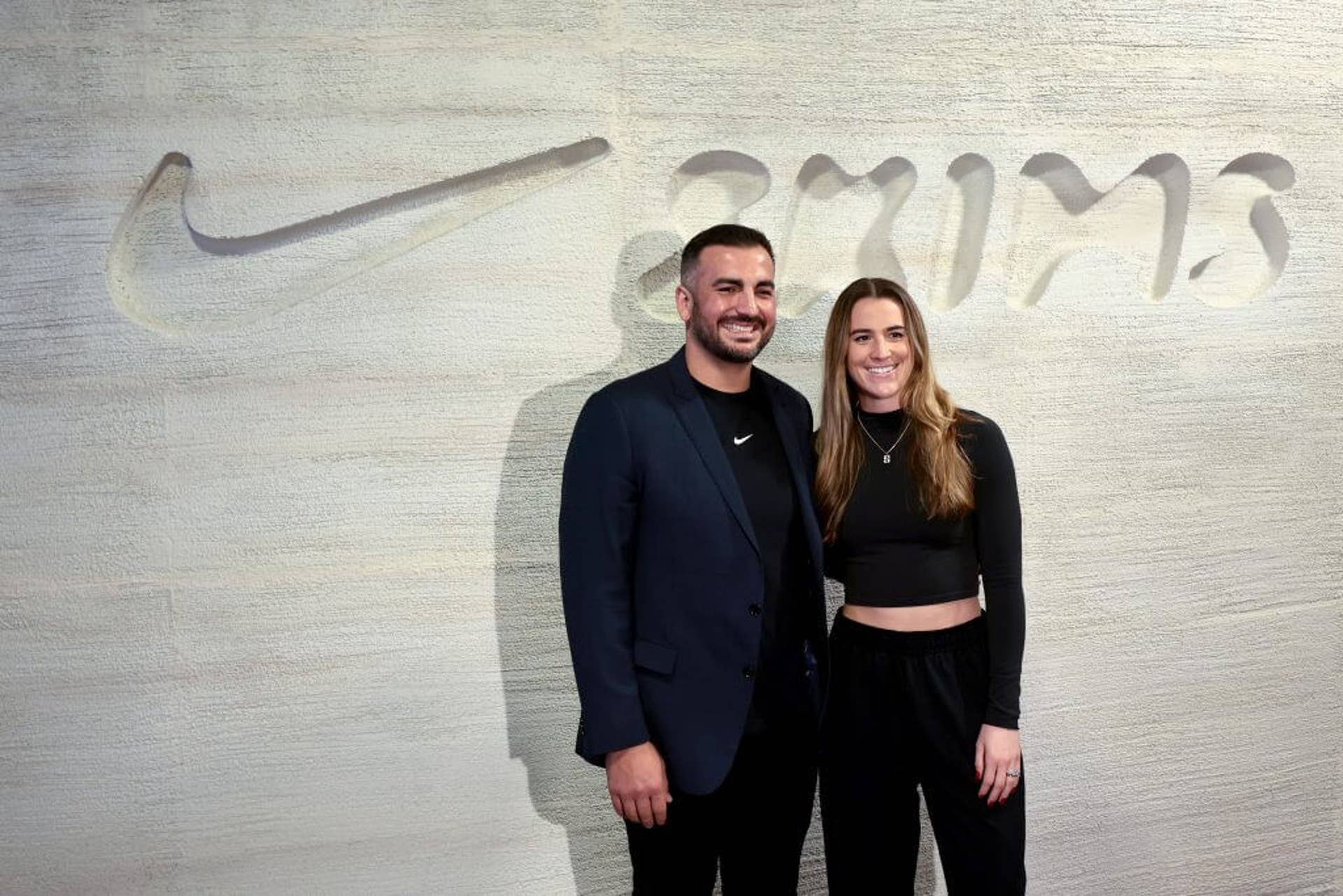 Sabrina Ionescu and her husband, Hroniss Grasu, pose for a photo at a Nike-Skims event.