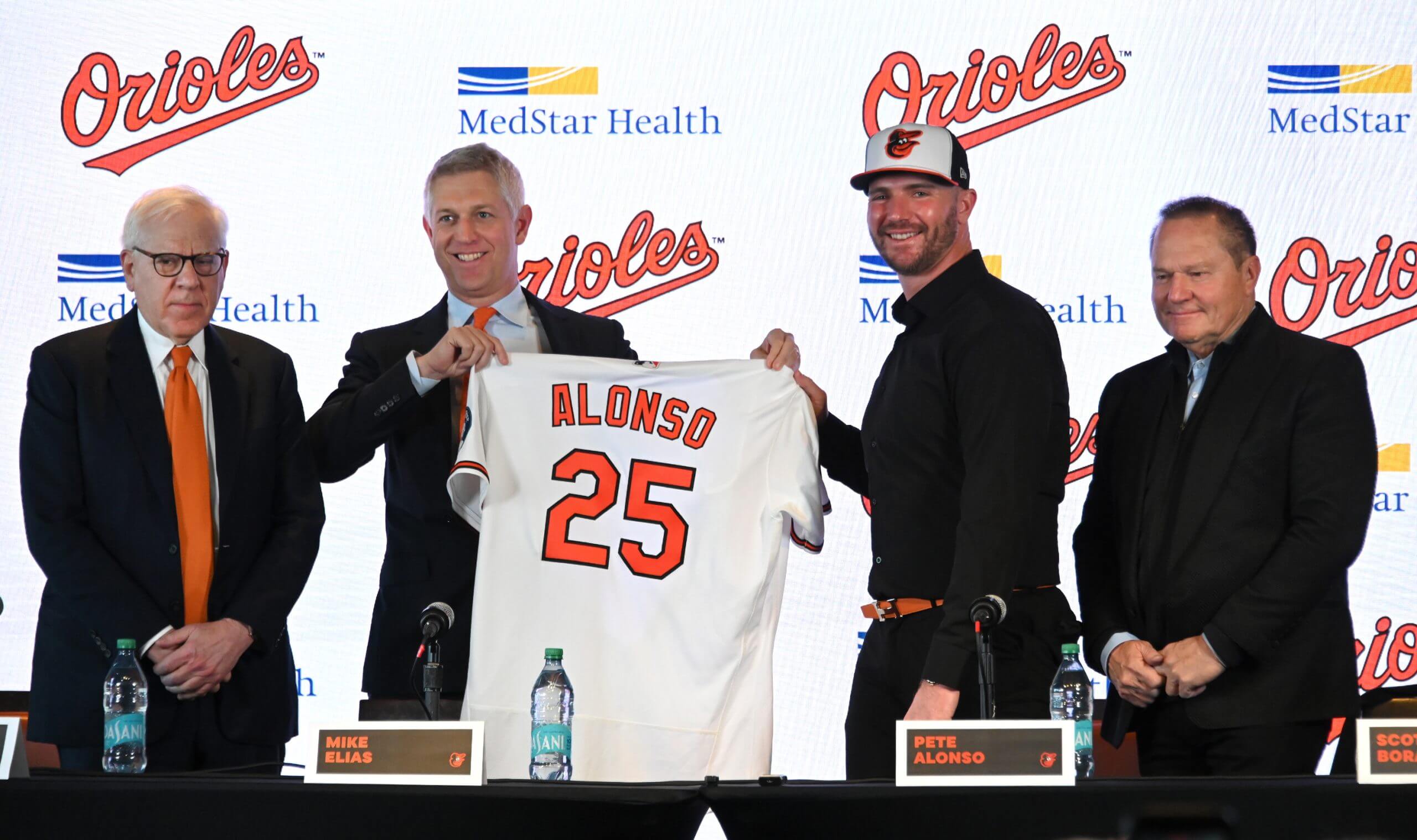 Orioles owner David Rubenstein, president of baseball operations Mike Elias and agent Scott Boras introduce new first baseman Pete Alonso at Camden Yards on Friday. 