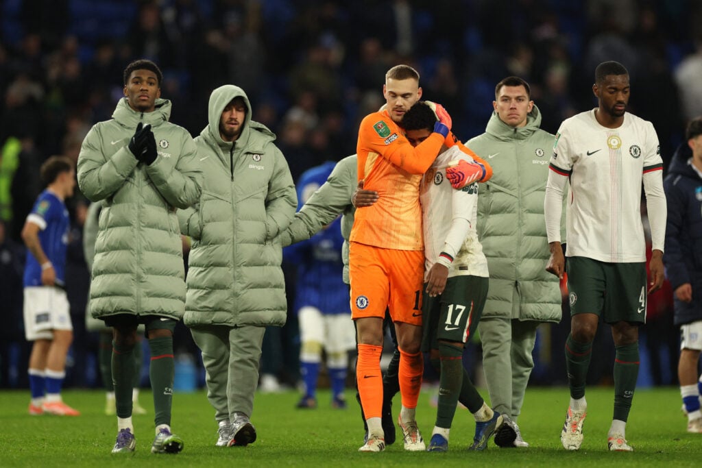 Chelsea's Swedish-Danish goalkeeper #12 Filip Jorgensen embraces Chelsea's Brazilian midfielder #17 Andrey Santos