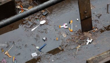 Used needles litter the ground