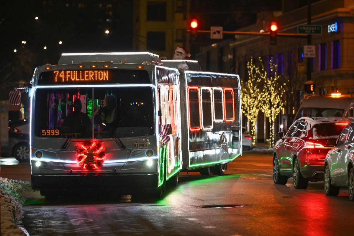 Bus decorated with Christmas lights turns onto a street.