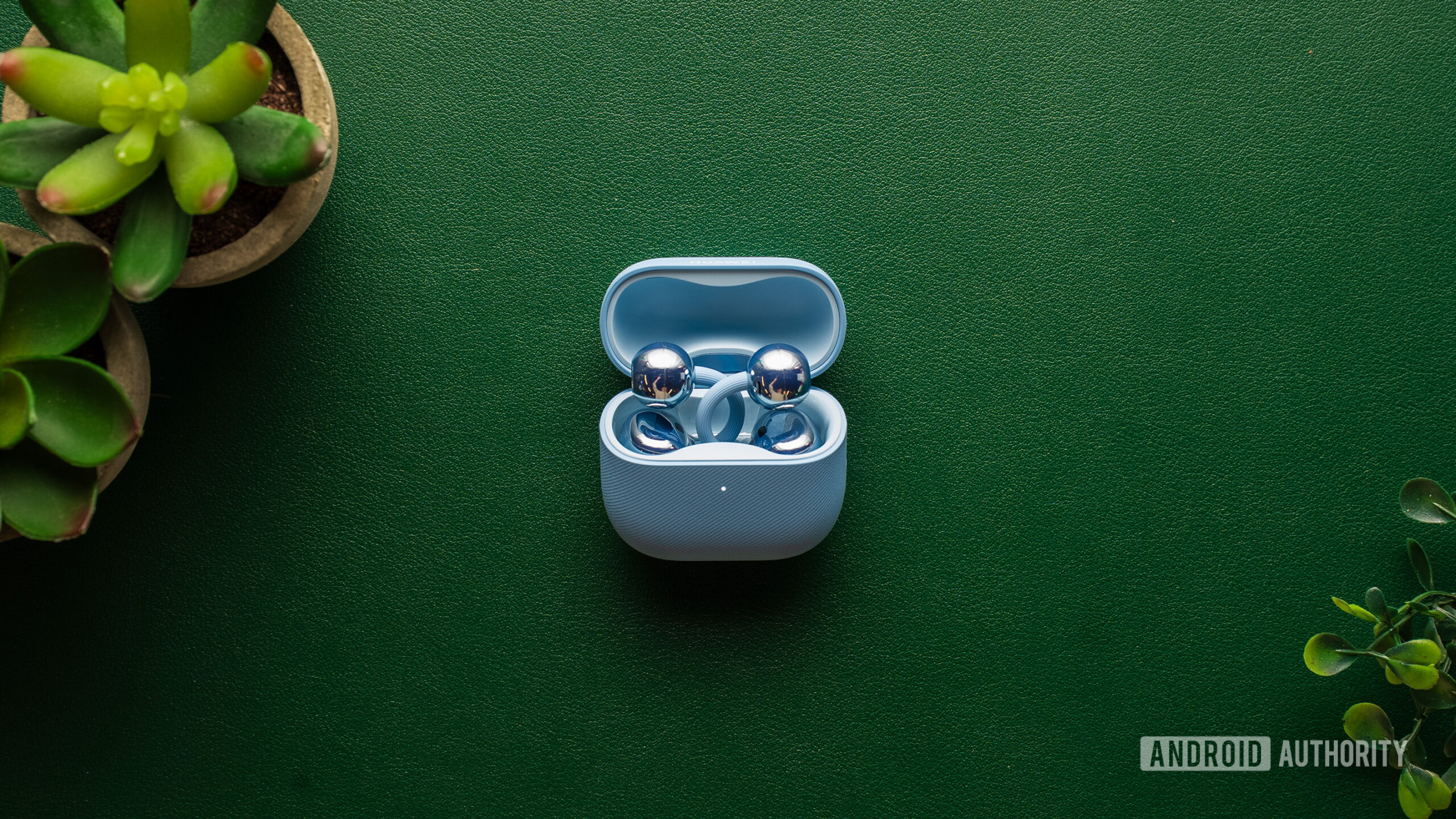 HUAWEI Free Clip 2 earbuds in case on table.