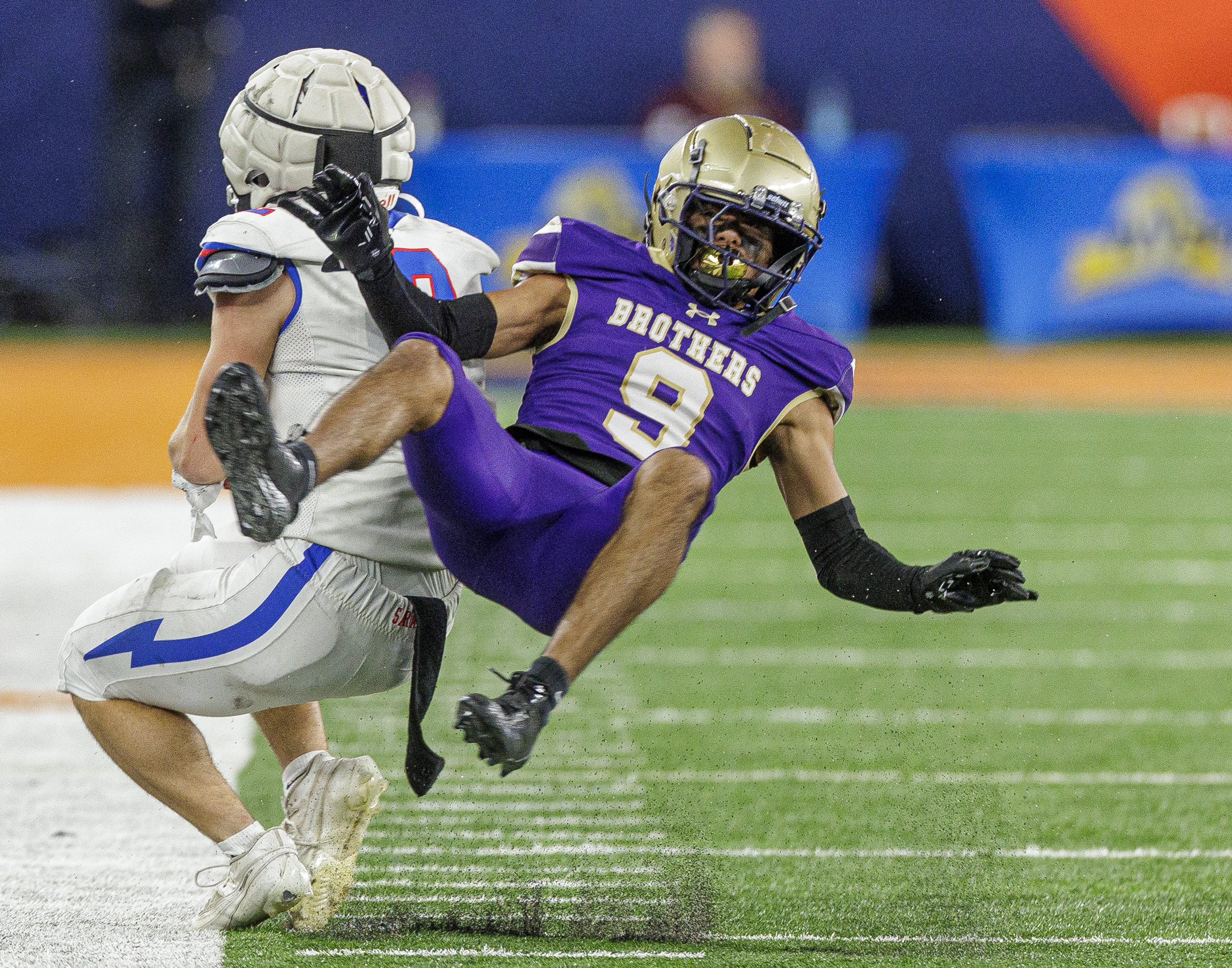CBA Brothers WRDB Adrian Weather (9) throws his body against Saratoga Springs Blue Streaks Benjamin Coryea (2) as the CBA Brothers and Saratoga Springs Blue Streaks fought for the New York State Class AA state title at JMA Wireless Dome Saturday, December 6, 2025. (N. Scott Trimble | strimble@syracuse.com)