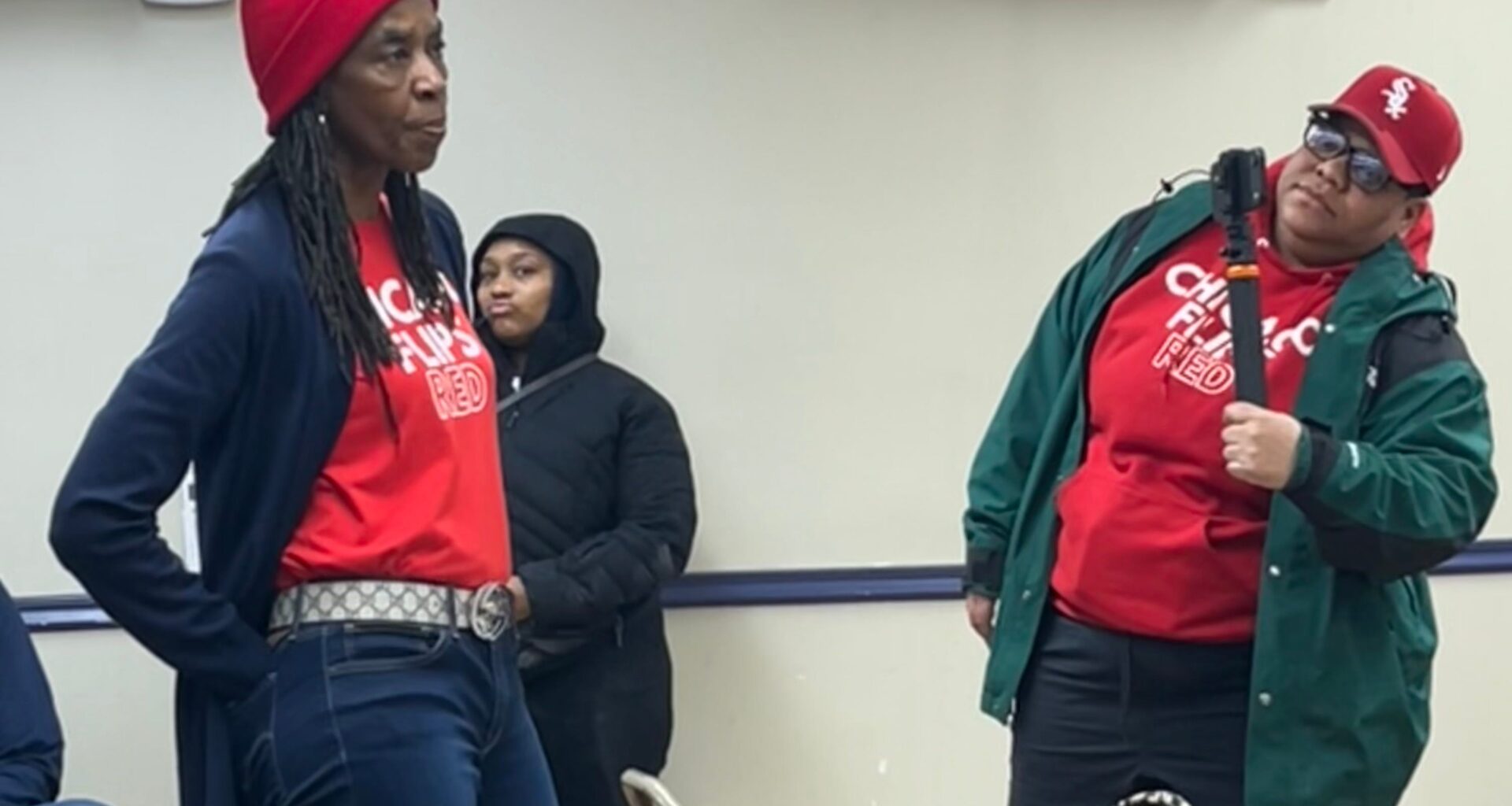 A member of the "Chicago Flips Red" group voices criticism of rising property taxes in the city during a union event featuring Mayor Brandon Johnson.