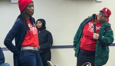 A member of the "Chicago Flips Red" group voices criticism of rising property taxes in the city during a union event featuring Mayor Brandon Johnson.